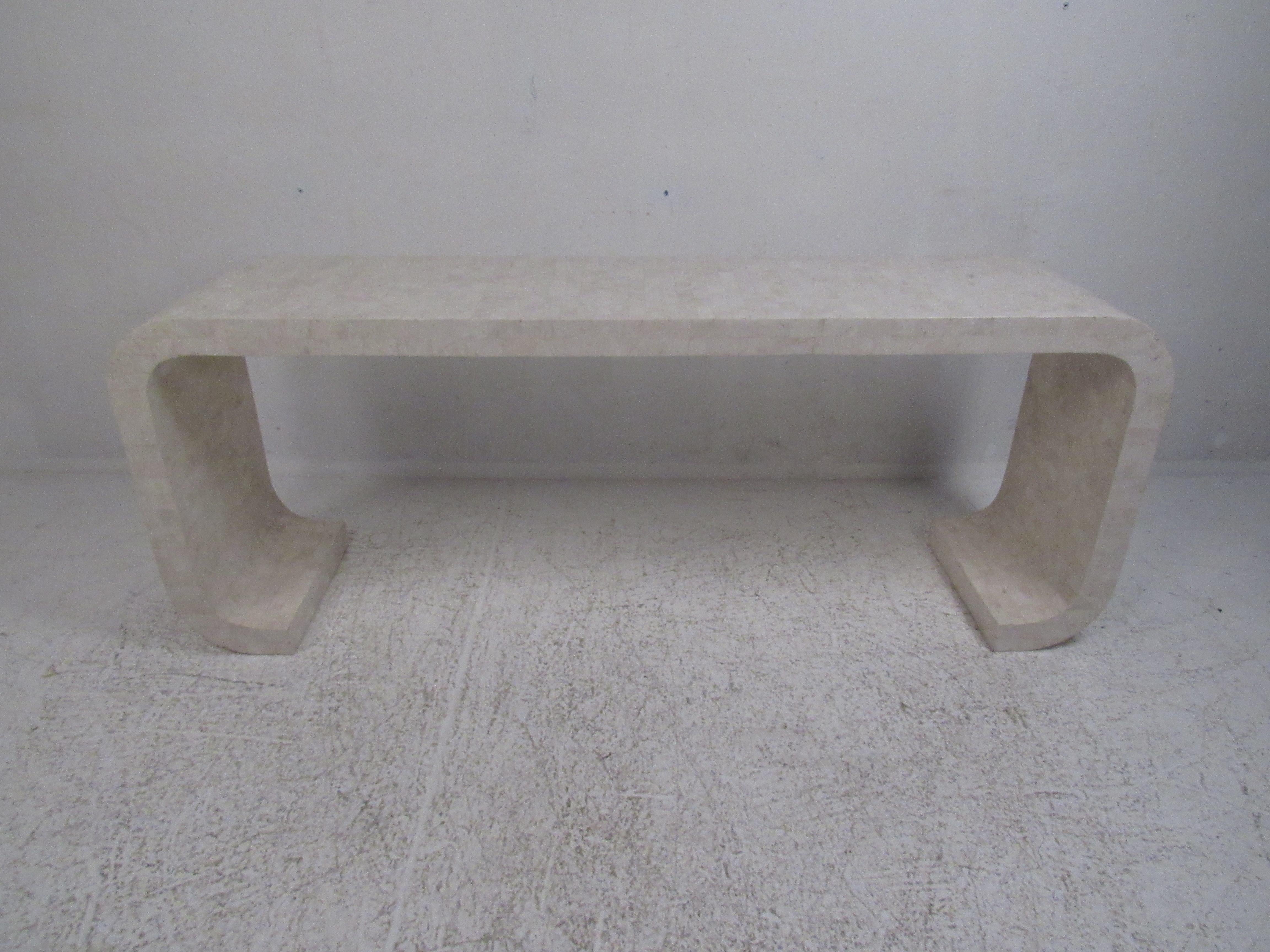 This impressive Mid-Century Modern console table boasts a waterfall design making it stand out in any modern interior. This elegant piece is made with tessellated stone and has a stamp underneath verifying its designer and origin. A stunning Karl