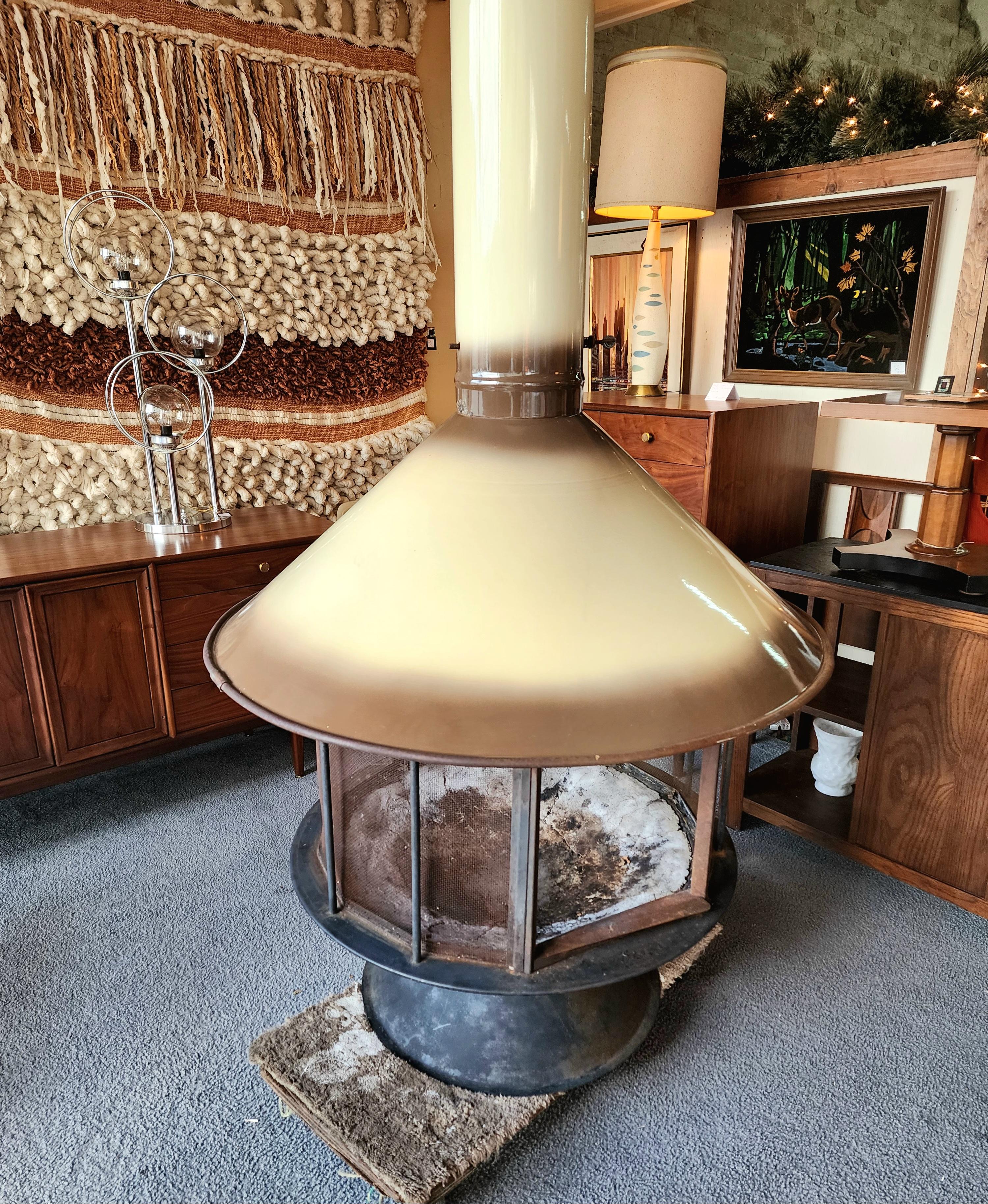 This Imperial Carousel Mid-Century Malm fireplace gives you a 360° view of the fire inside! It has the iconic tulip base with a porcelain color that fades into brown with a cone top. This wonderful design makes an impact inside or out that gives
