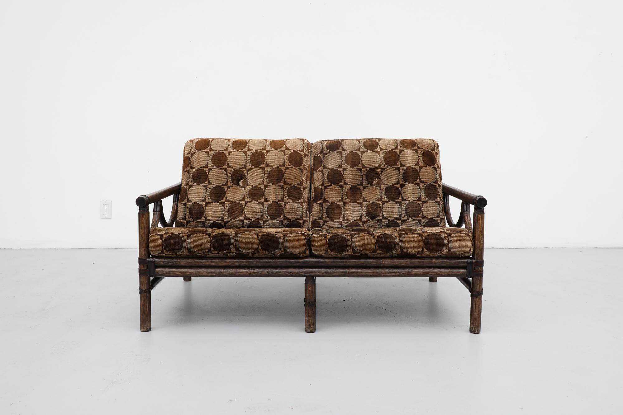 1970s thick bamboo framed loveseat with original Verner Panton cushions. The cushions are visibly aged and worn, yet still intact. The frame is in good original condition with signs of wear consistent with its age and use.