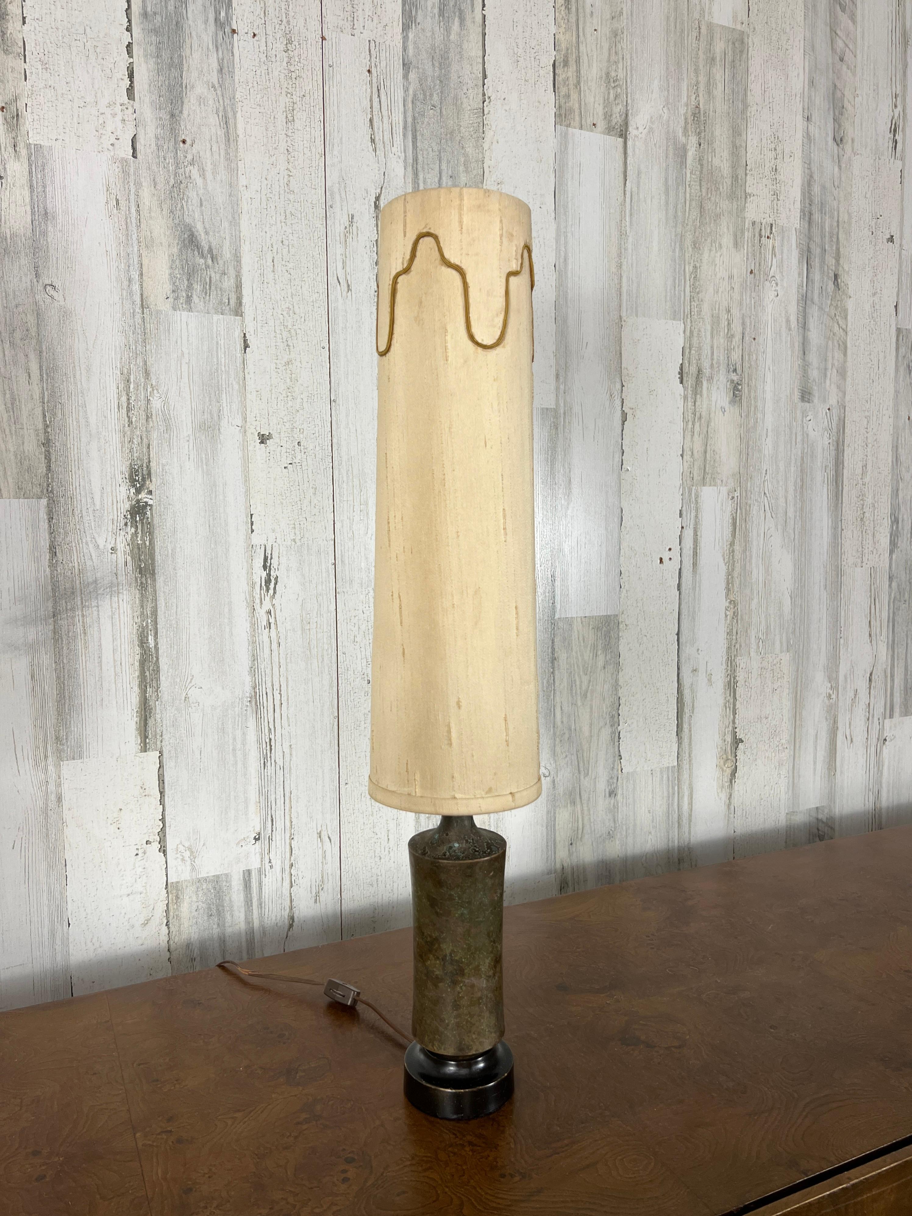 Tall and narrow modernist table lamp. Marble with ebonized wood base and the original cloth shade.
