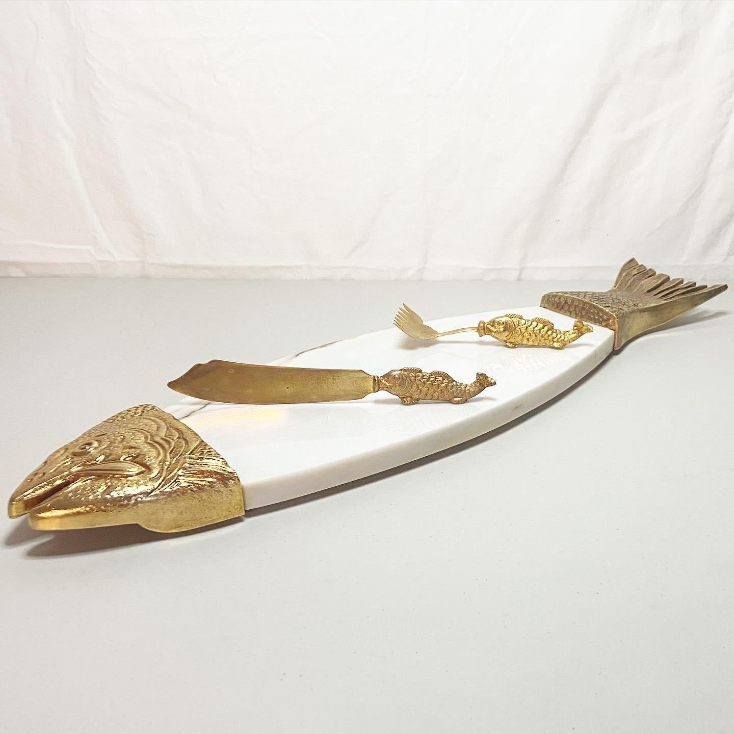 Elegant marble & brass fish serving platter with matching brass knife and fork.

Knife measures 9”L
Fork measures 6.5”L.