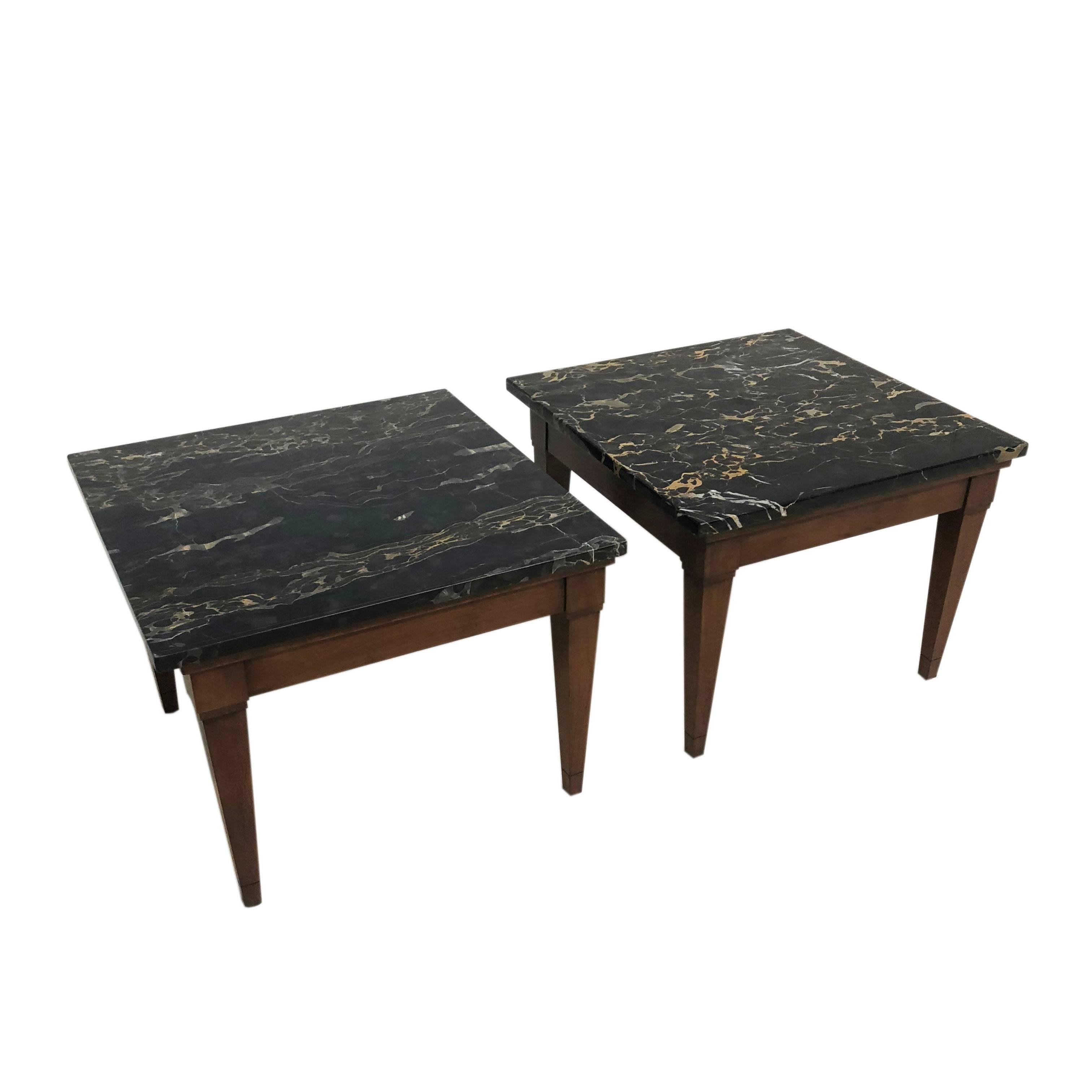 Mid-Century Modern end tables with walnut wood bases and black marble tops made in Italy. Age appropriate wear. Some slight scratching on the stone surface.

Measurements: 22
