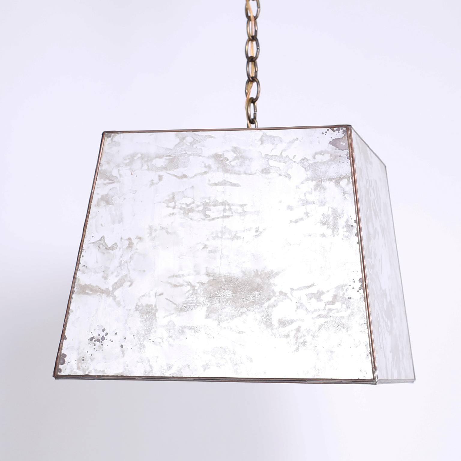 Unique midcentury pendant with marbleized and oxidized mirrored panels in a trapezoid form. The bottom has an open square that casts light down.