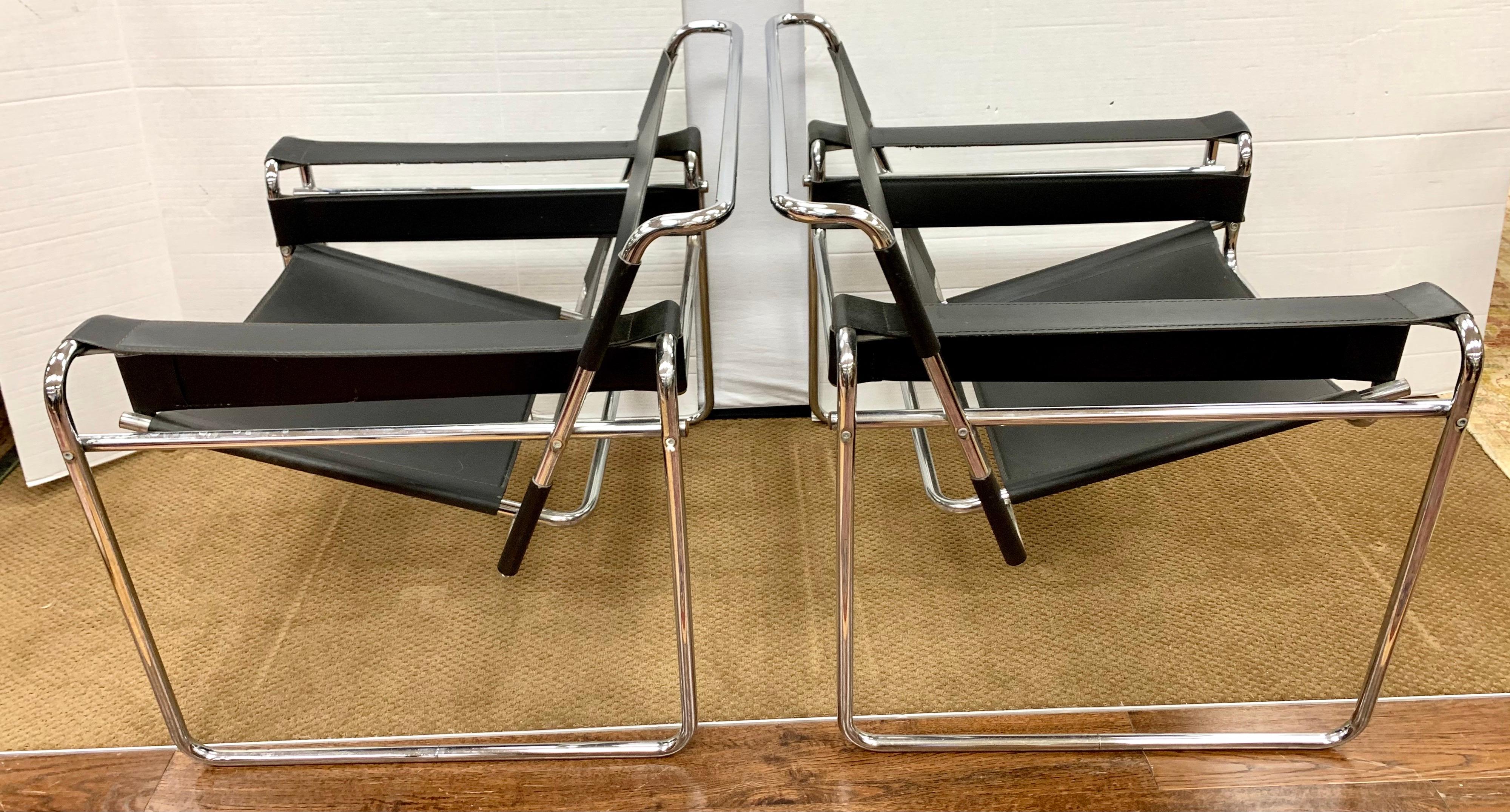 Mid century iconic Marcel Breuer style Wassily chairs in black leather and tubular steel chrome.
In great vintage condition with light wear on leather.