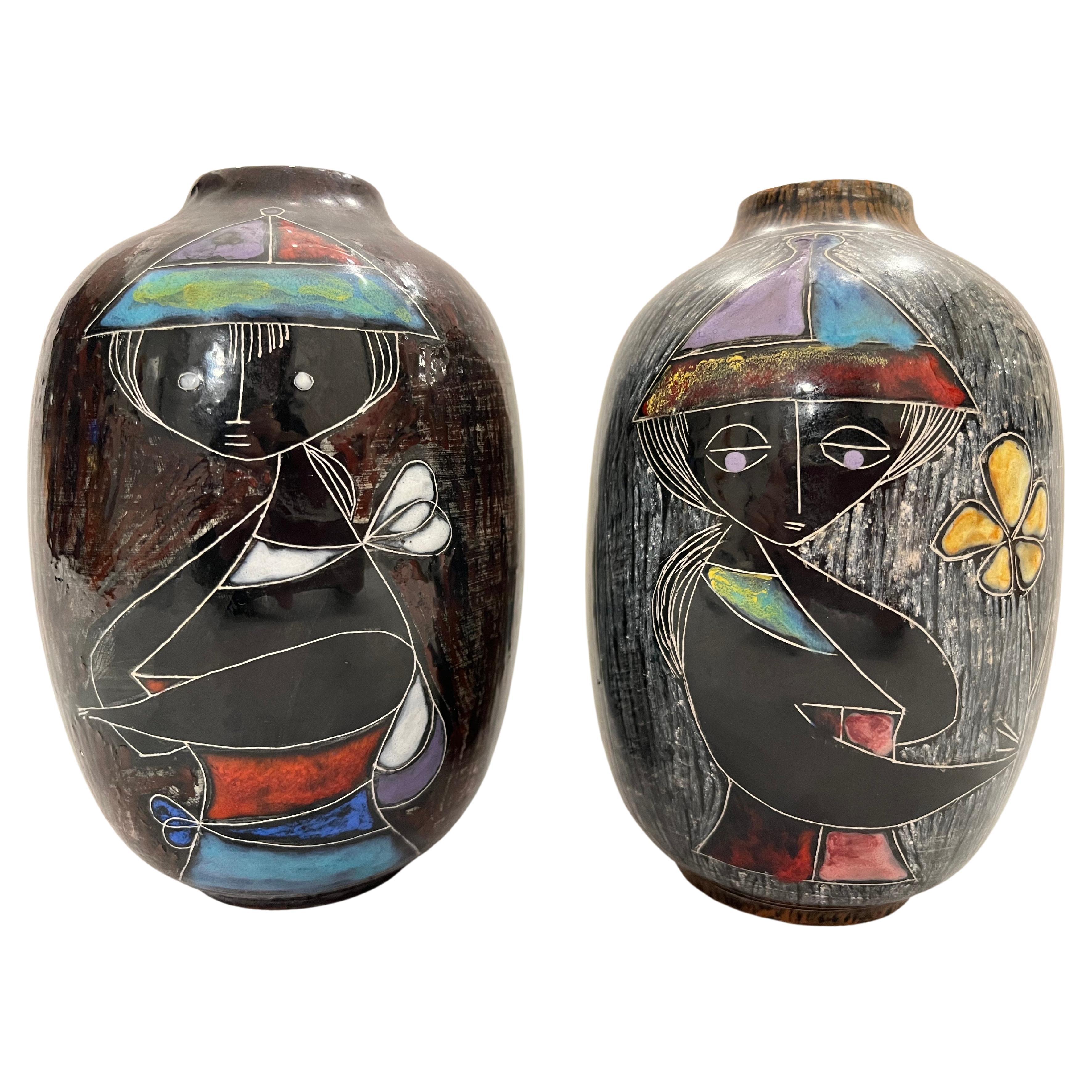 Two beautifully detailed vases by Italian artist Marcello Fantoni. Each vase presents in a wonderful colored in sgraffito style a portrait of a fetching woman. Each vase is signed on the bottom with one also being signed on the side. The vases are