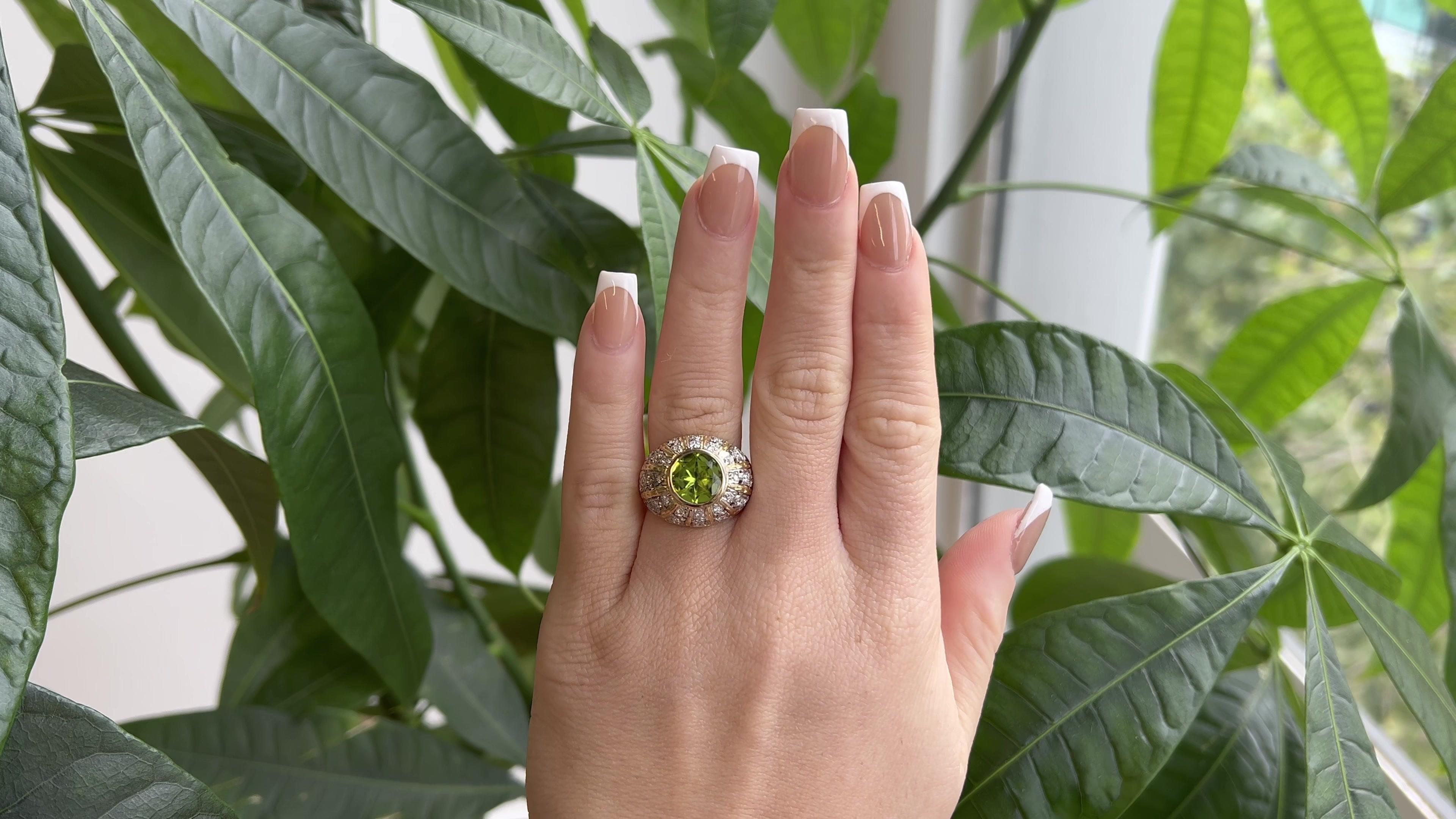 One Mid Century Mario Buccelatti Italian Peridot Diamond 18 Karat Gold Bezel Set Dome Ring. Featuring one round peridot of approximately 2.90 carats. Accented by 32 round brilliant cut diamonds with a total weight of approximately 0.70 carat, graded