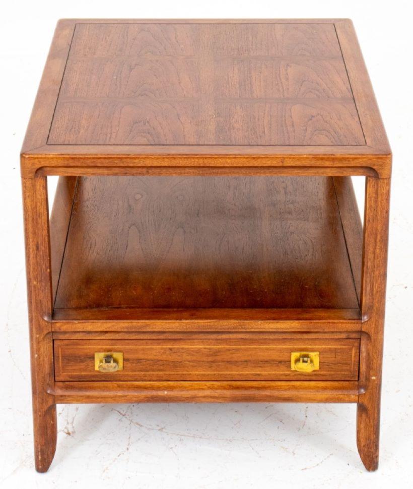 Mid-Century Mastercraft wood lamp table, rectangular with marquetry top above a lower tier with drawer with hinged brass tab pulls above canted feet, label to interior of drawer. 22
