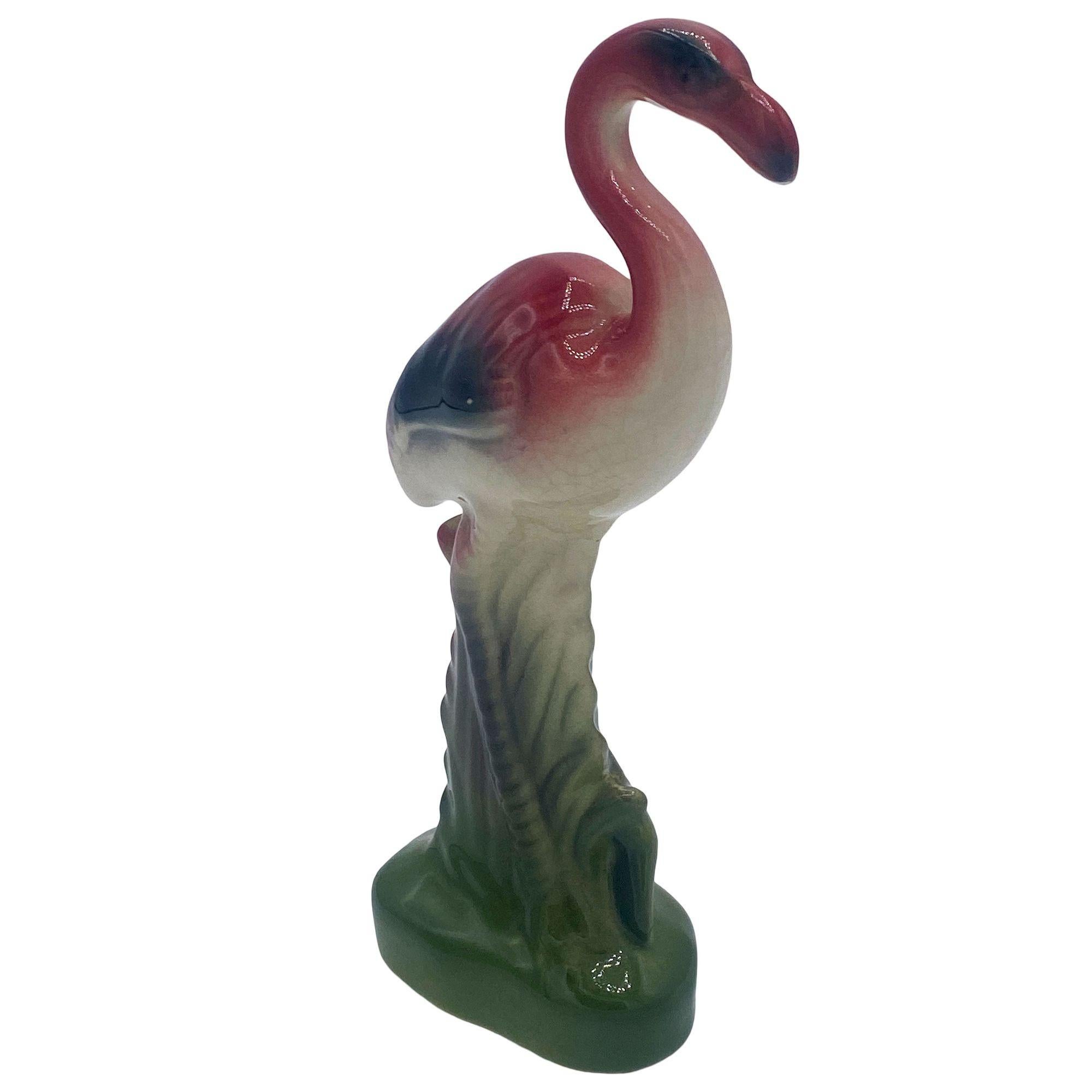 Mid-century pink and green miniature ceramic flamingo tabletop California pottery vase set of matching His and Her set . The set features two beautifully detailed pink flamingos in lush green leaves and grass with a pink color. Each comes with a