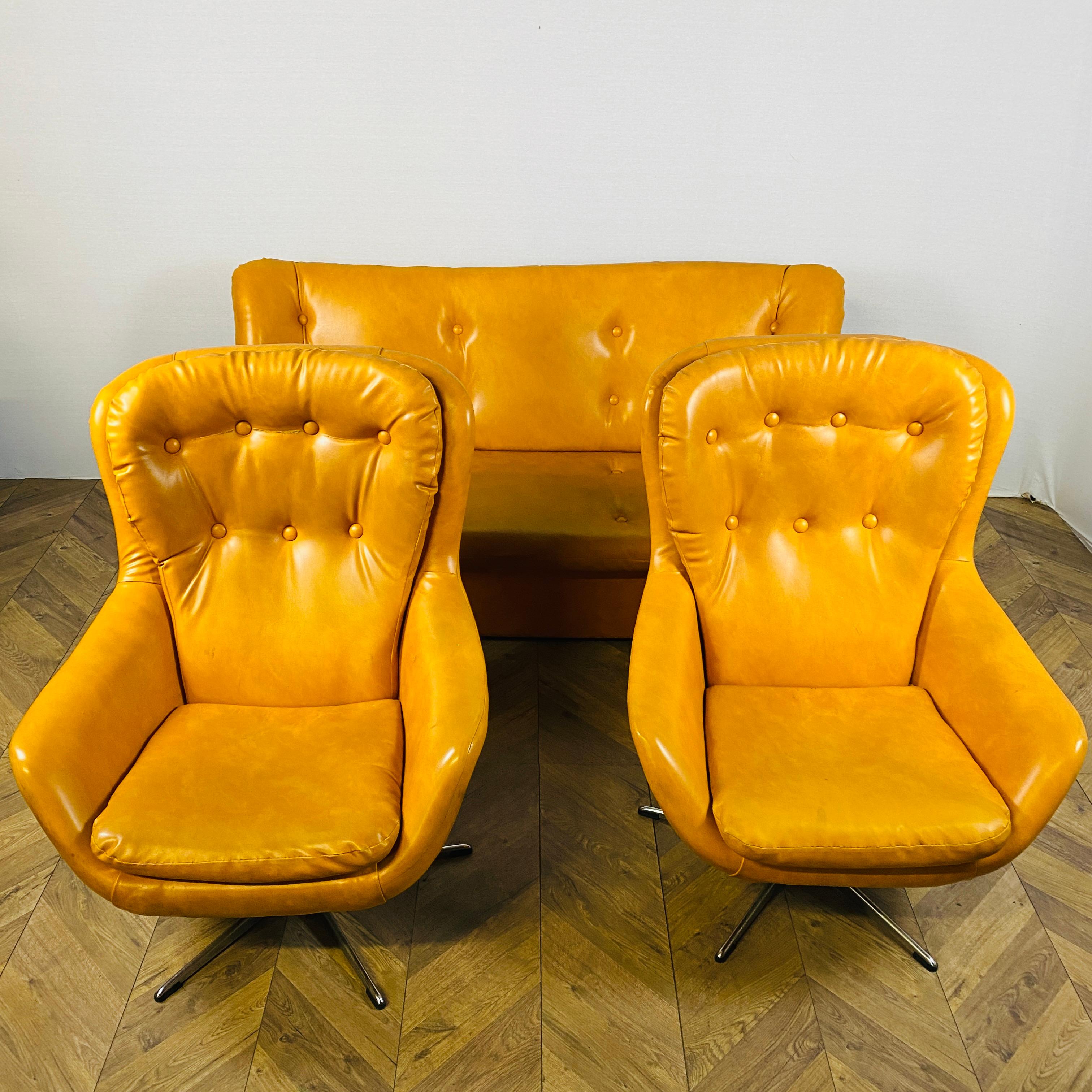 Wonderfully Retro sofa set, Consisting of a 2-seater sofa and 2 matching swivel egg chairs on chrome legs. 

The set is made from a light tan vinyl material and in good vintage condition, with only slight marks and scuffs, in-keeping with their