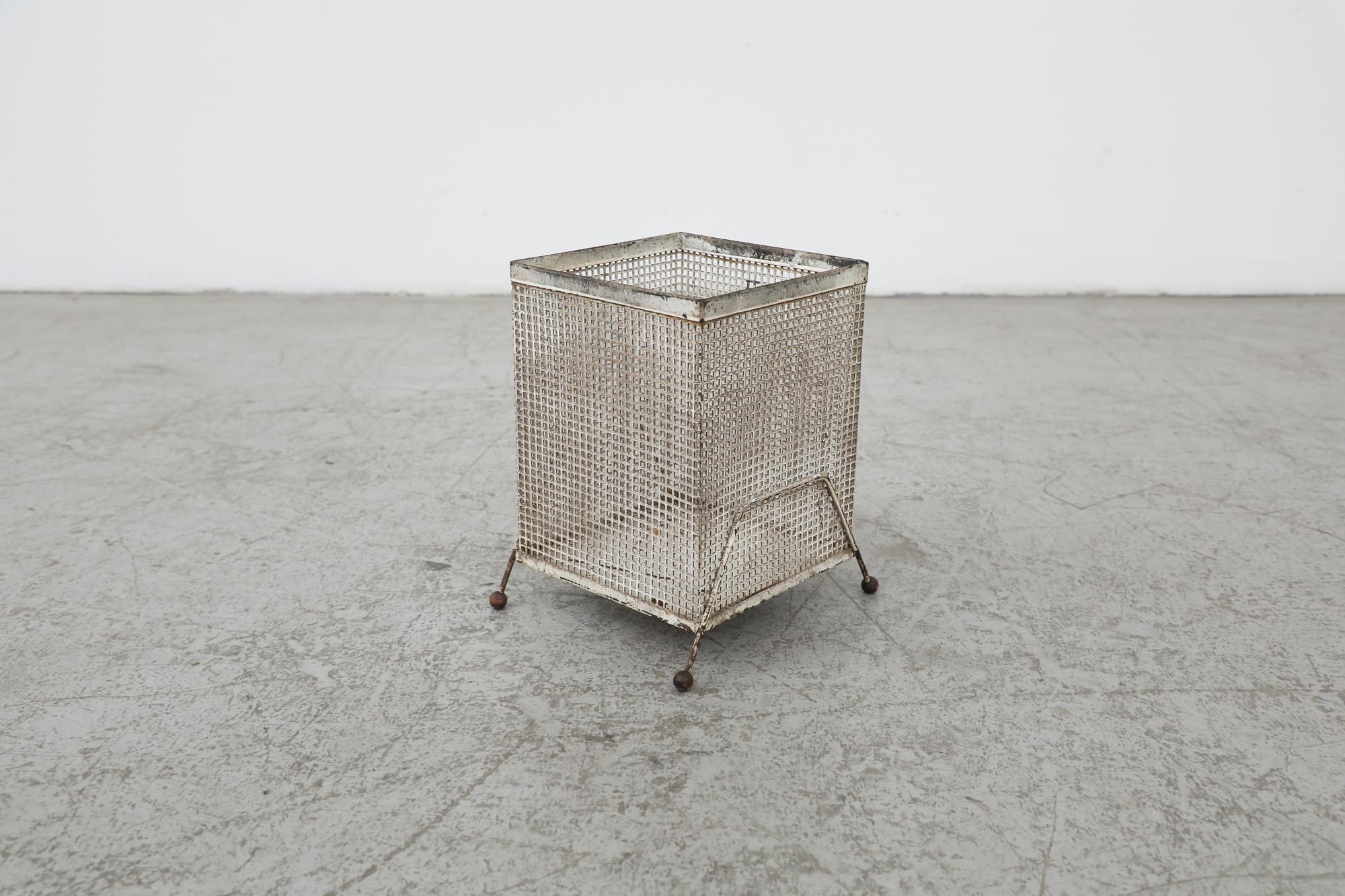 Mategot (attr) perforated metal waste basket or umbrella stand with perforated metal sides, sheet metal base with little round wood tipped wire legs. In very original condition with heavy patina and visible wear consistent with its age and use.