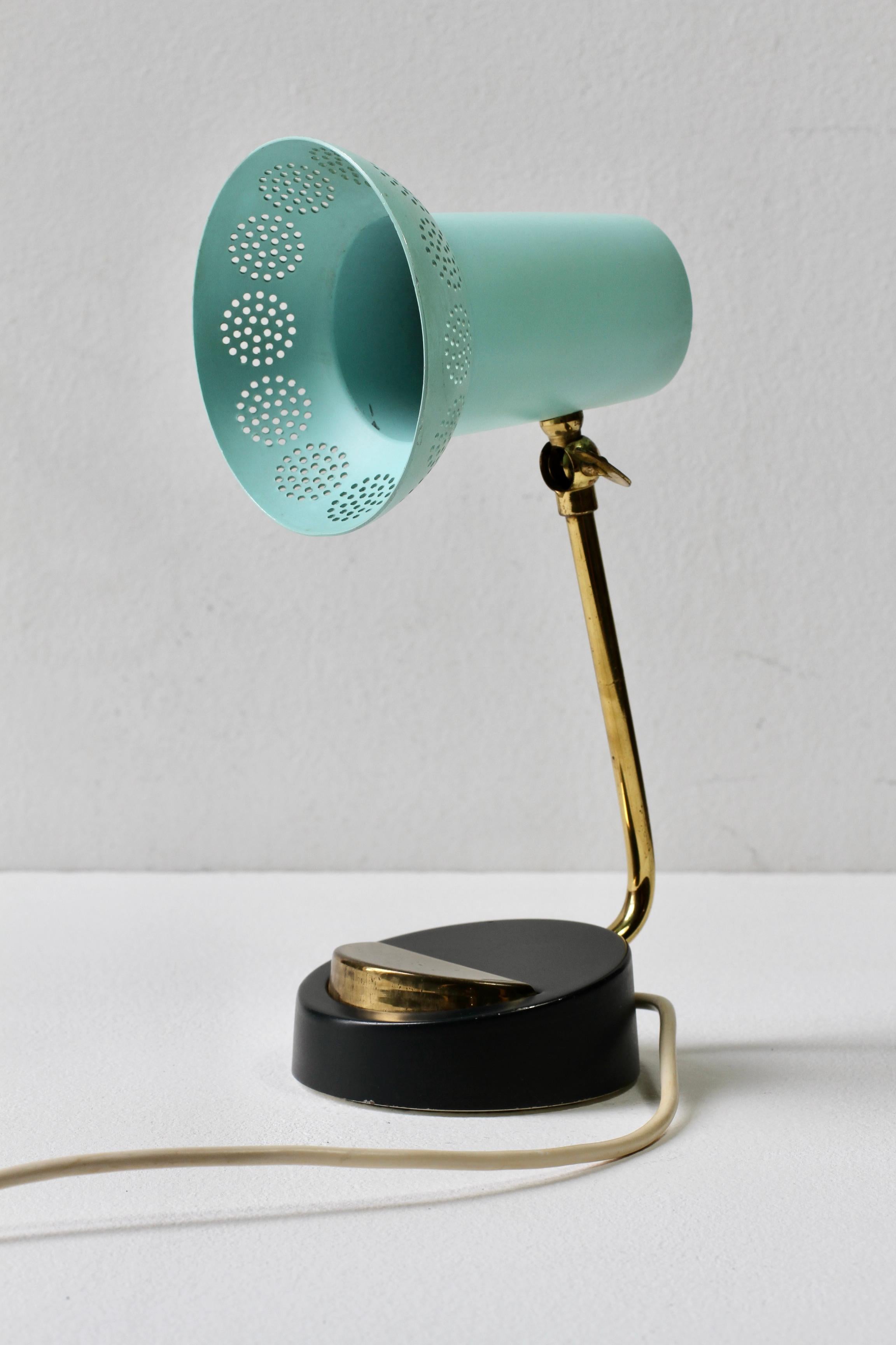 Vintage midcentury modern bedside table light or desk lamp in the style of Mathieu Matégot, circa 1950s-1960s. The perforated adjustable mint green / turquoise metal shade is also similar to German designer Ernst Igl's lights for Hillebrand