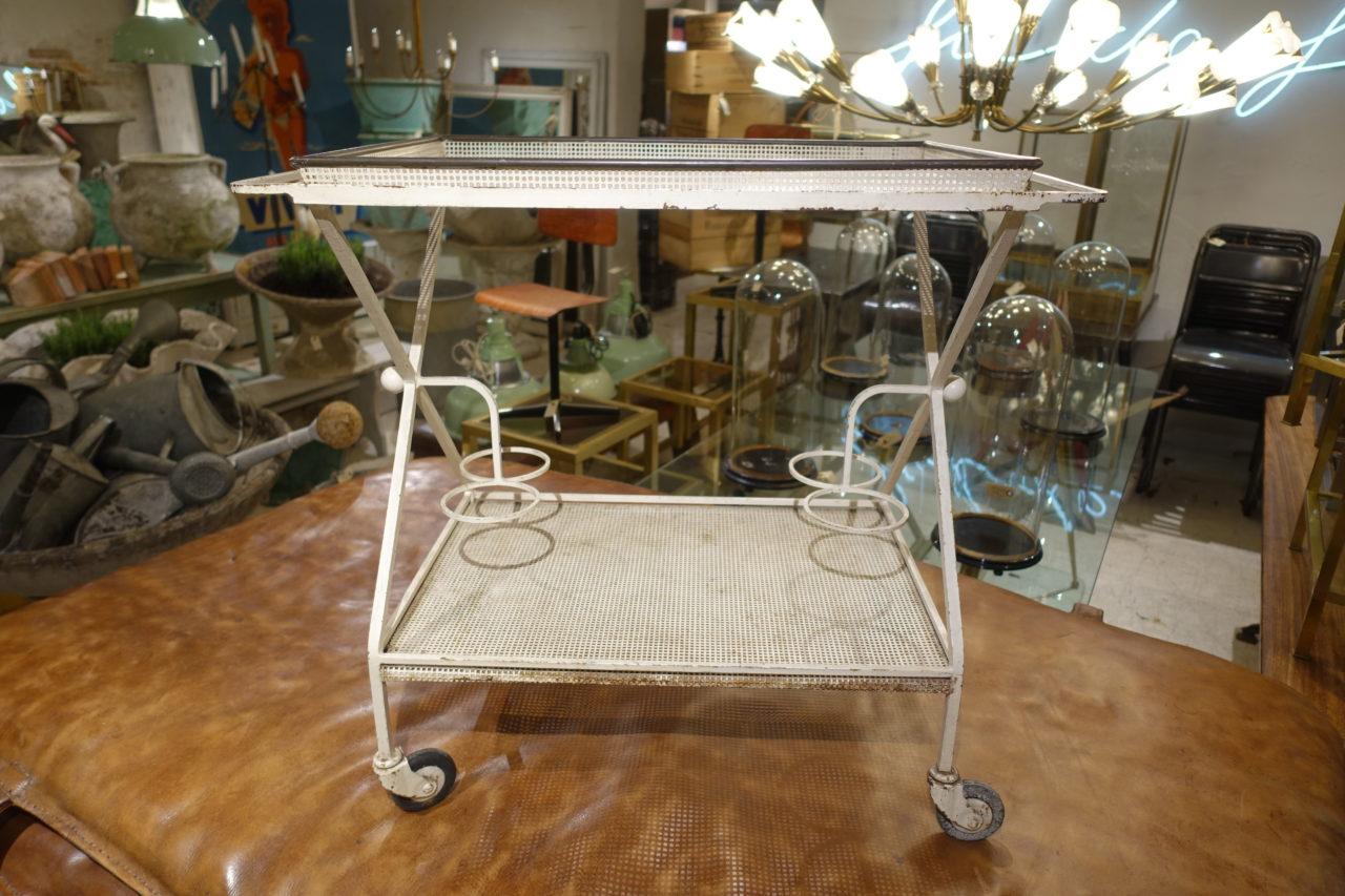 Cool vintage serving trolley or bar cart, designed in the 1950s by Frenchman Mathieu Matégot. Charming white painted perforated ironwork, with removable brass edged trays. Bottle holders underneath. Gorgeous on a patio or in a kitchen or pavillion