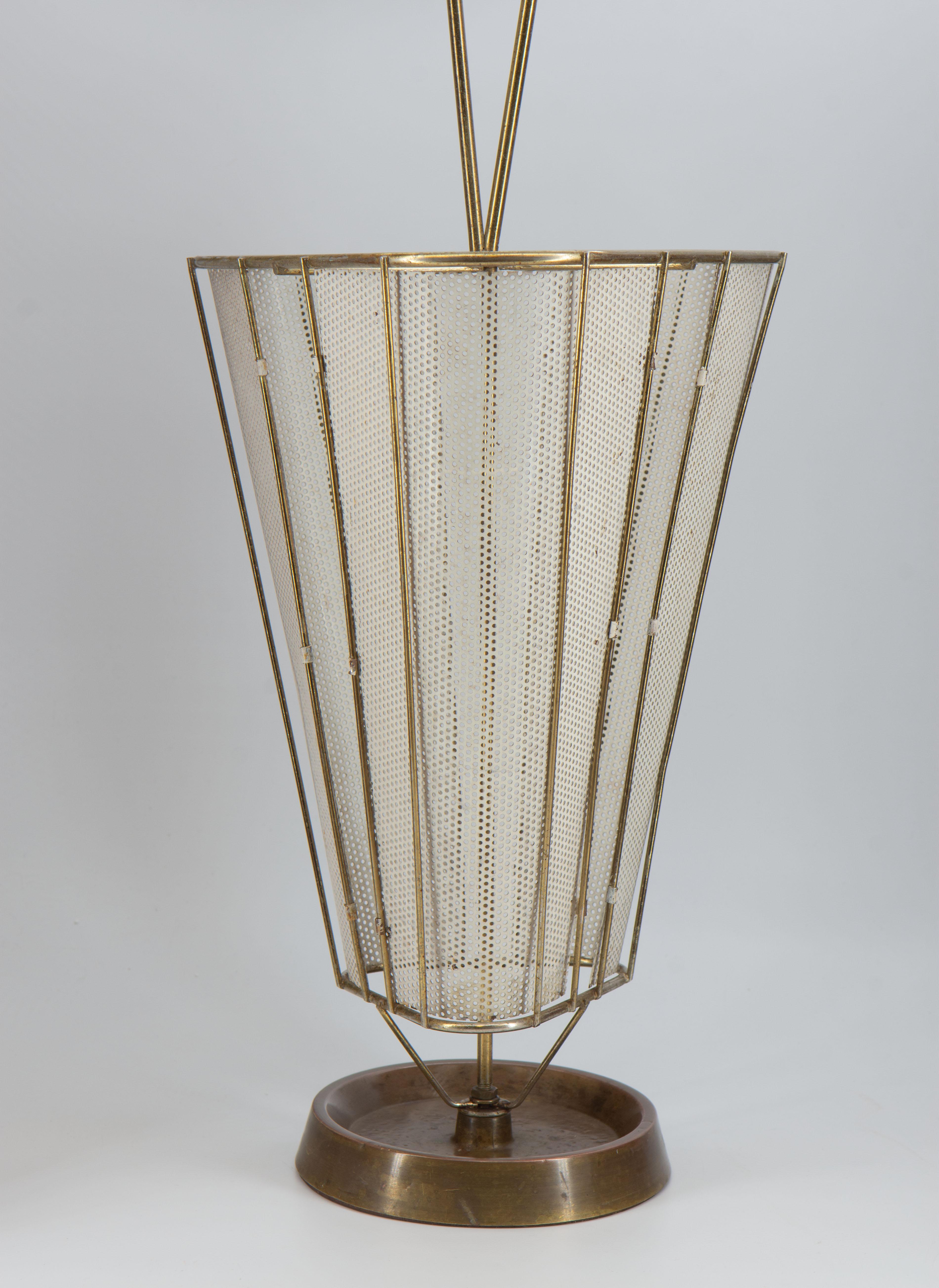 Mid-Century Mathieu Mategot style elegant umbrella stand. Circa 1950. 

Delivery included to mainland UK.

With a tubular metal frame, the stand is composed of off-white basket with perforated detail, terminating in a brass-lined drip tray over