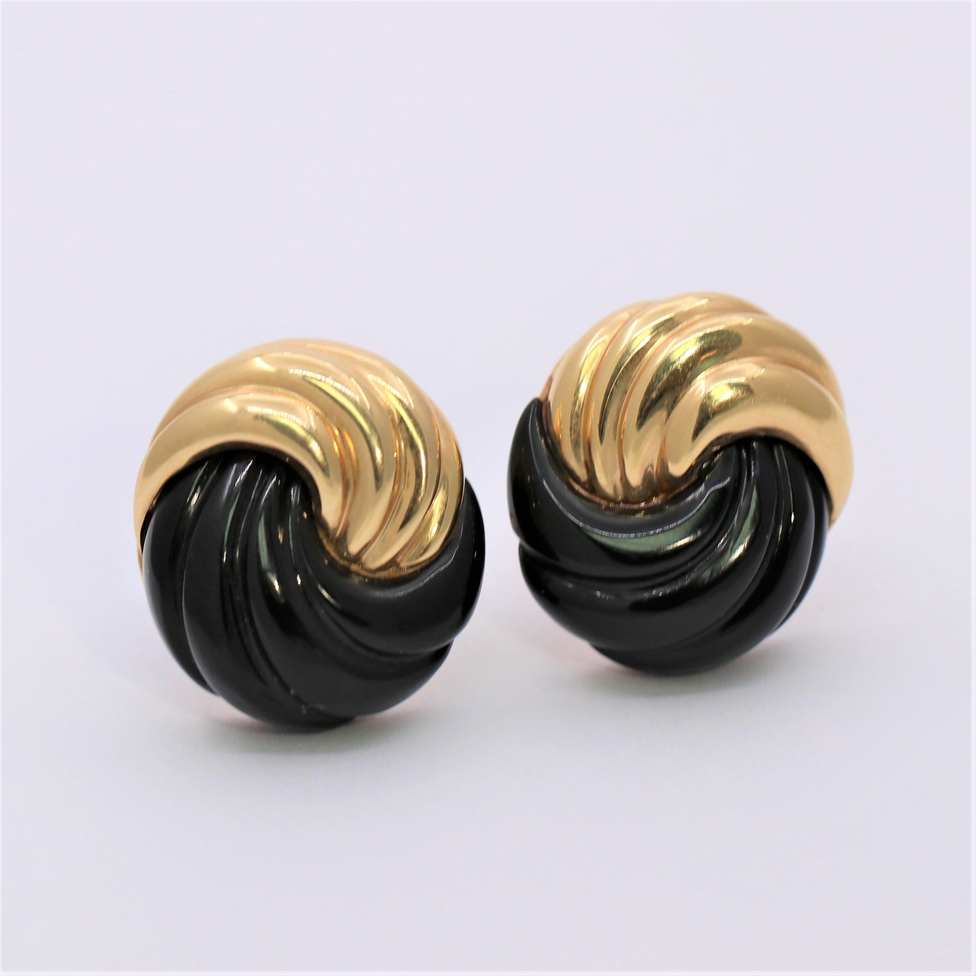 Made by designer MAZ, this classic knot design pair of earrings is crafted in fluted, 14K Yellow Gold and fluted, black onyx sections. The graceful flow  is seamless and creates a beautiful visual as well as  a sense of delicate motion. Measures 1