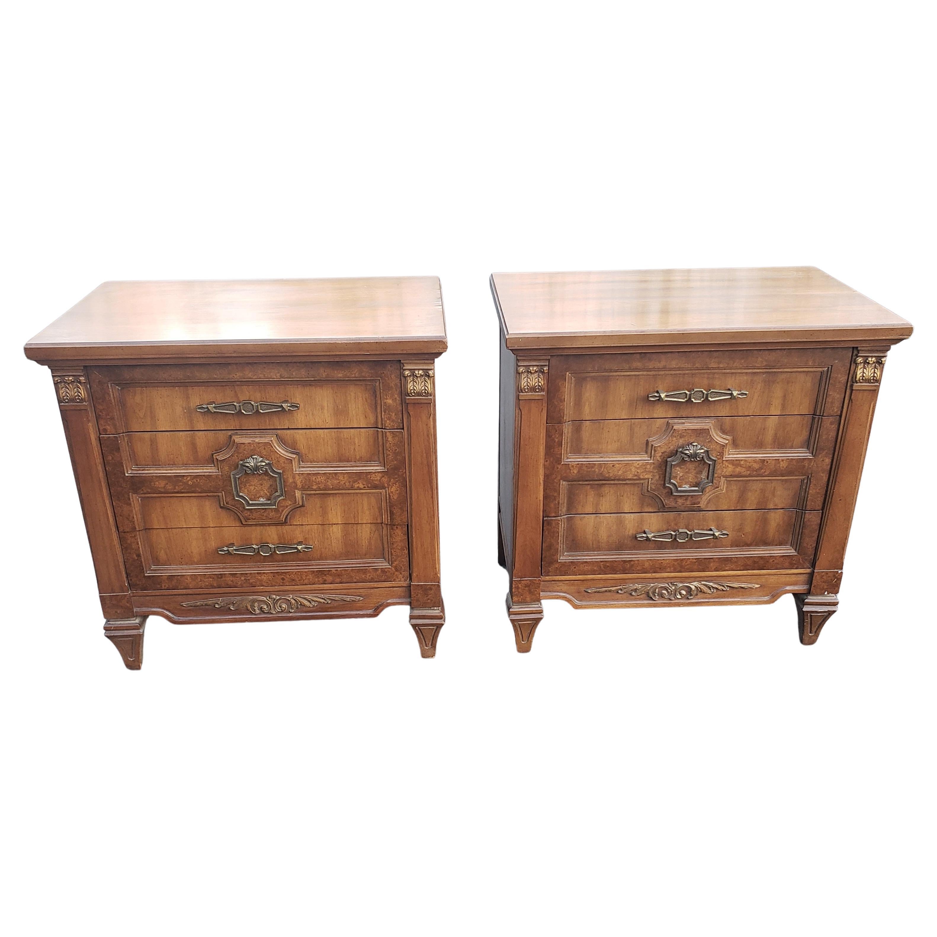 Pair of midcentury Mazor nasterpiece burl walnut bedside tables with giltwood accents and original hardware.
Measures 26