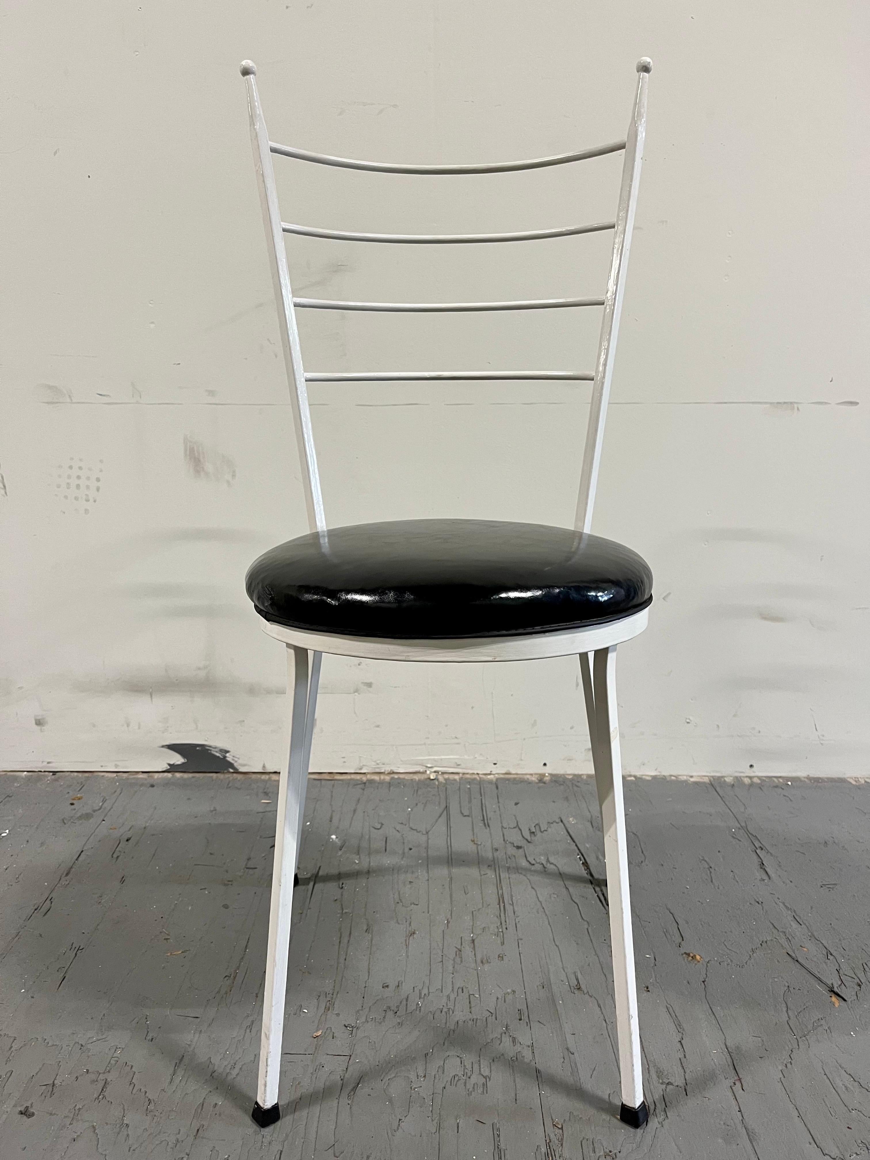 Sleek modern wrought iron chairs in the style of Paul McCobb.  Great period look with high slender ladder backs and ball finials. Striking contrast with black patten leather or vinyl cushions. 
Curbside to NYC/Philly $400