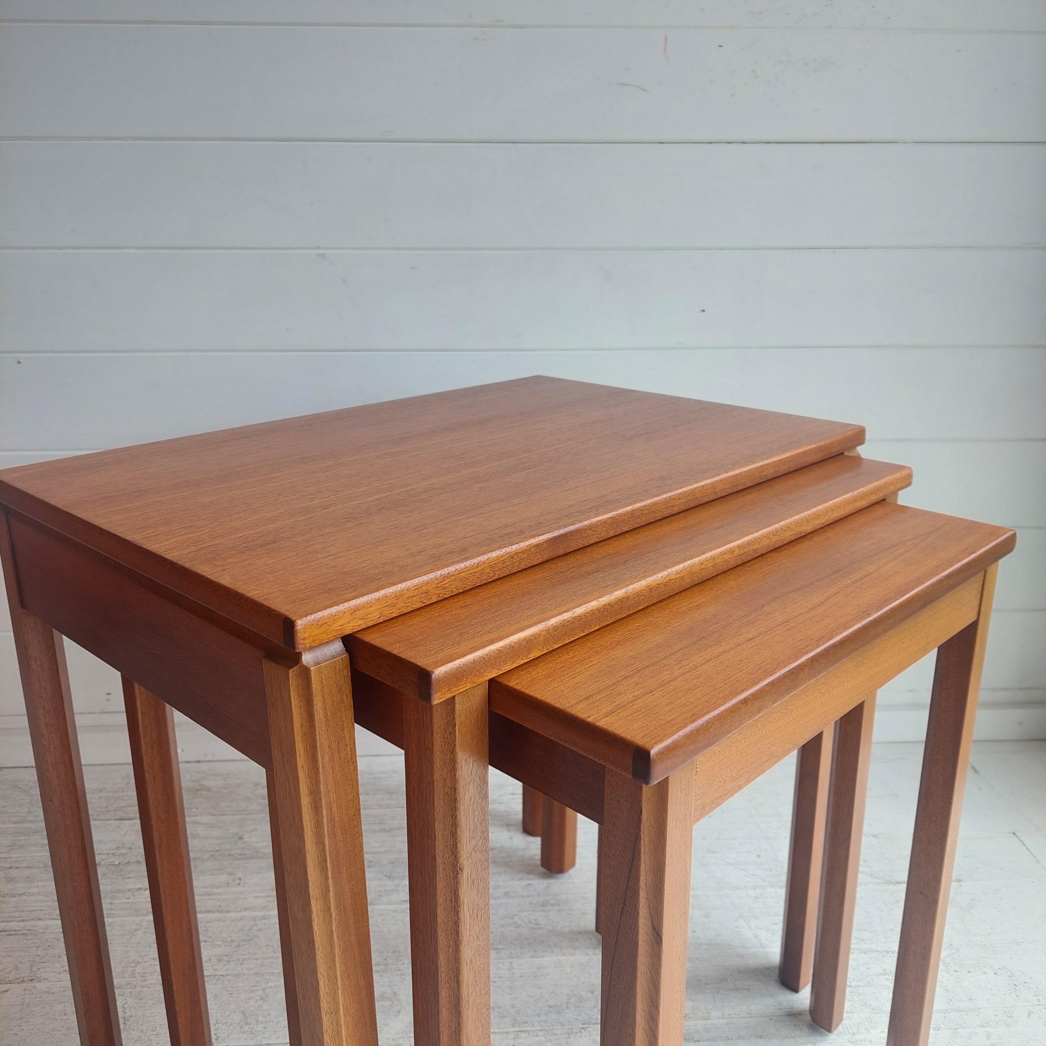 Nest of teak tables.
Made by A.H McIntosh & Co Ltd, Kirkcaldy Scotland, this retro 1970s.
They would be the perfect mid-century addition to your home. 
Inspired by Danish design, these tables have a beautiful, warm teak wood tone.

The three tables