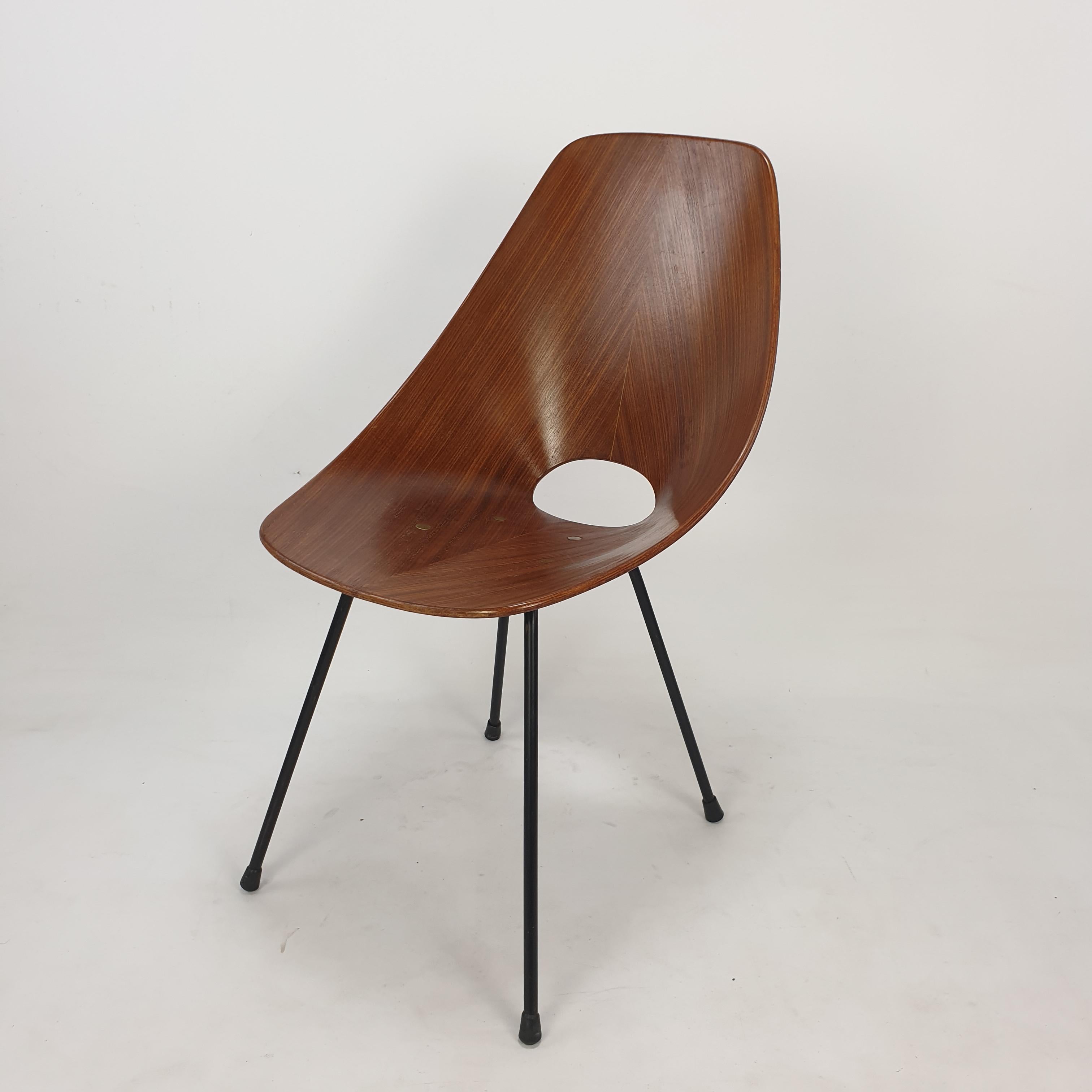 Very beautiful Italian ‘Medea’ chair designed by Vittorio Nobili for Fratelli Tagliabue in 1955. 

Molded teak wood seat supported by black steel legs, accented with brass hardware. 

A perfect representation of the organic modern style. 
The