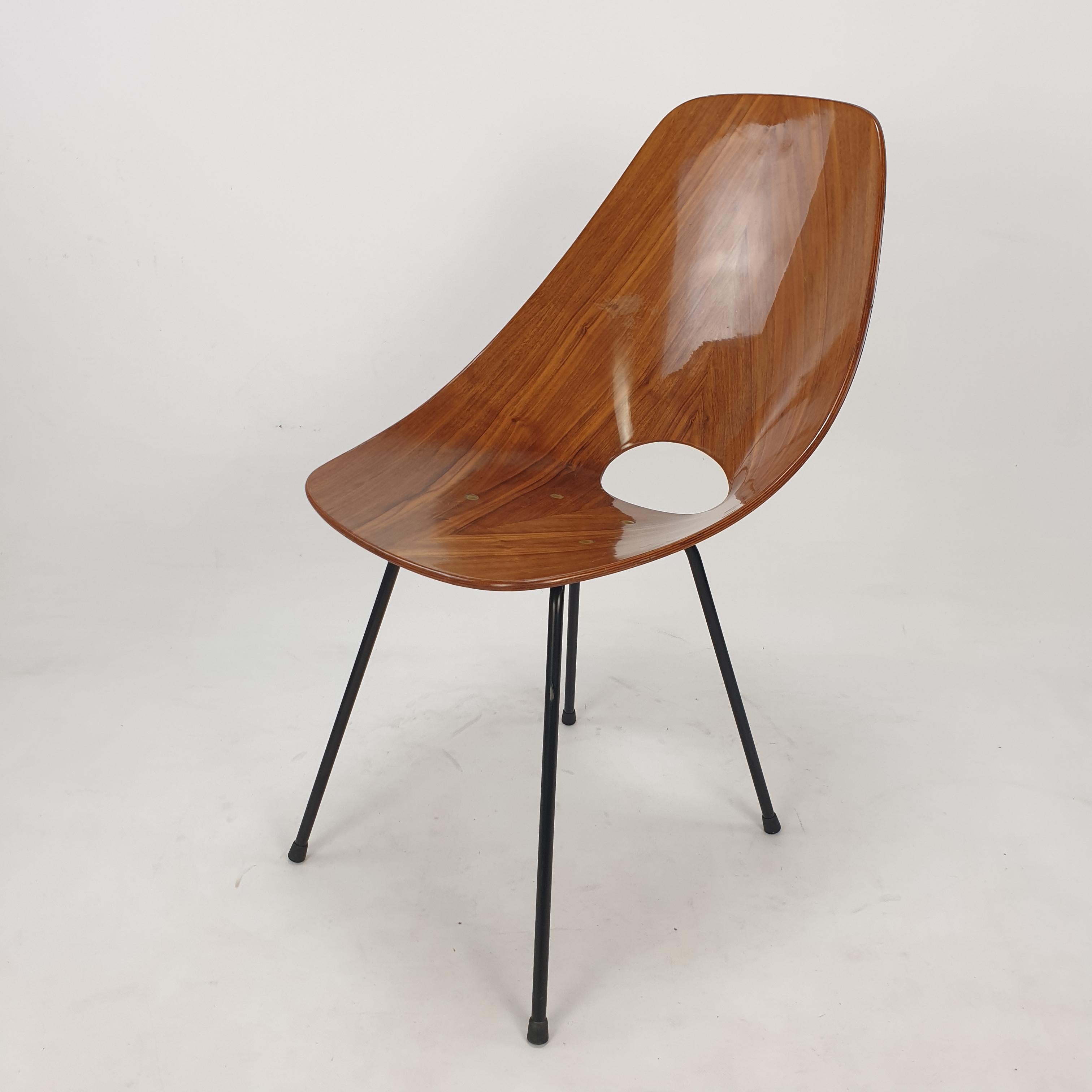 Beautiful Italian ‘Medea’ chair designed by Vittorio Nobili for Fratelli Tagliabue in 1955. 

Molded teak wood seat supported by black steel legs, accented with brass hardware. 

A perfect representation of the organic modern style. 
The