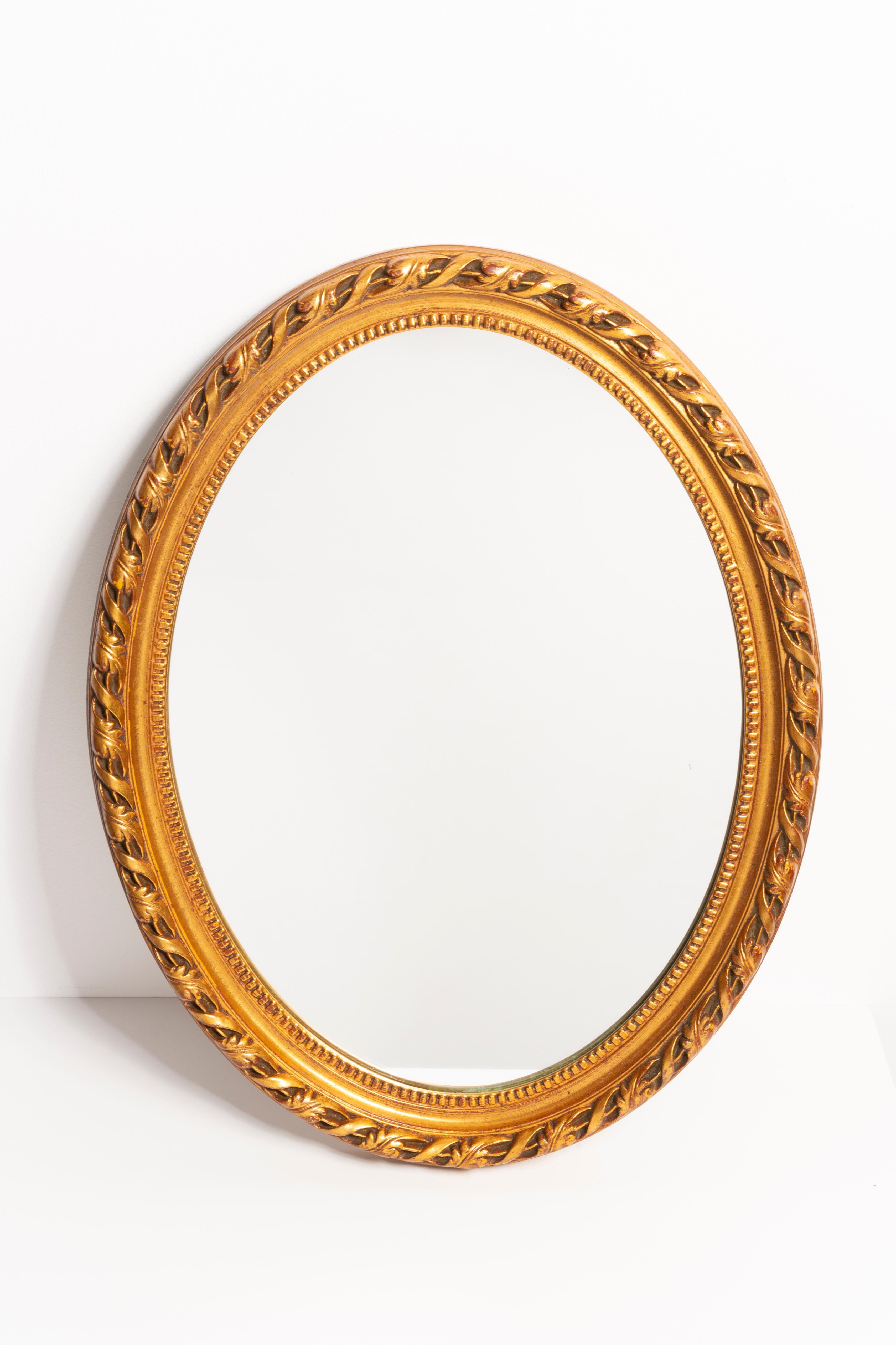 A beautiful oval mirror in a golden decorative frame with flowers from Italy. The frame is made of wood. Mirror is in very good vintage condition, no damage or cracks in the frame. Original glass. Beautiful piece for every interior! Only one unique