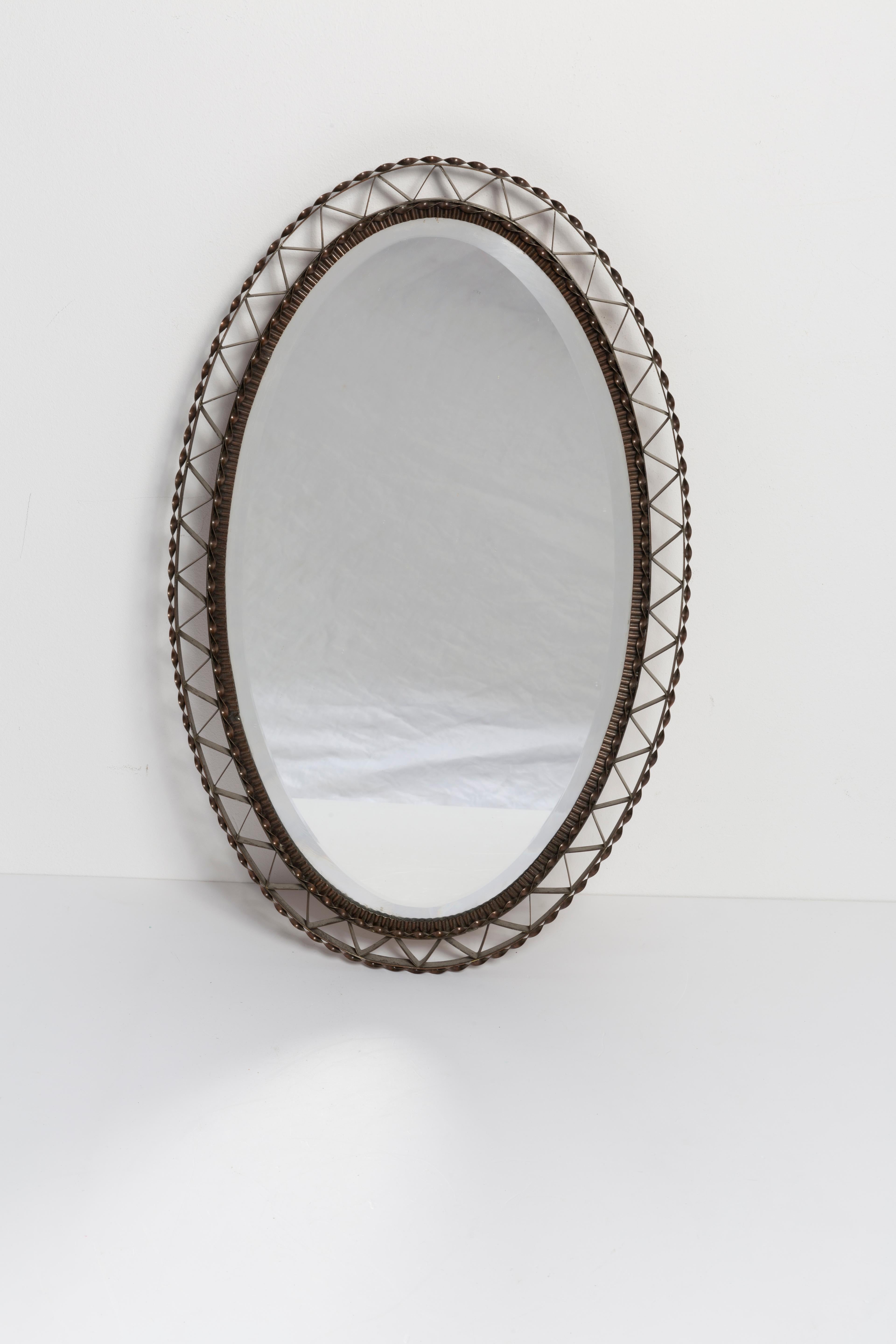 A mirror in a dark decorative frame from Italy. The frame is made of metal. Mirror is in very good vintage condition, no damage or cracks in the frame. Original glass. Beautiful piece for every interior! Only one unique piece.