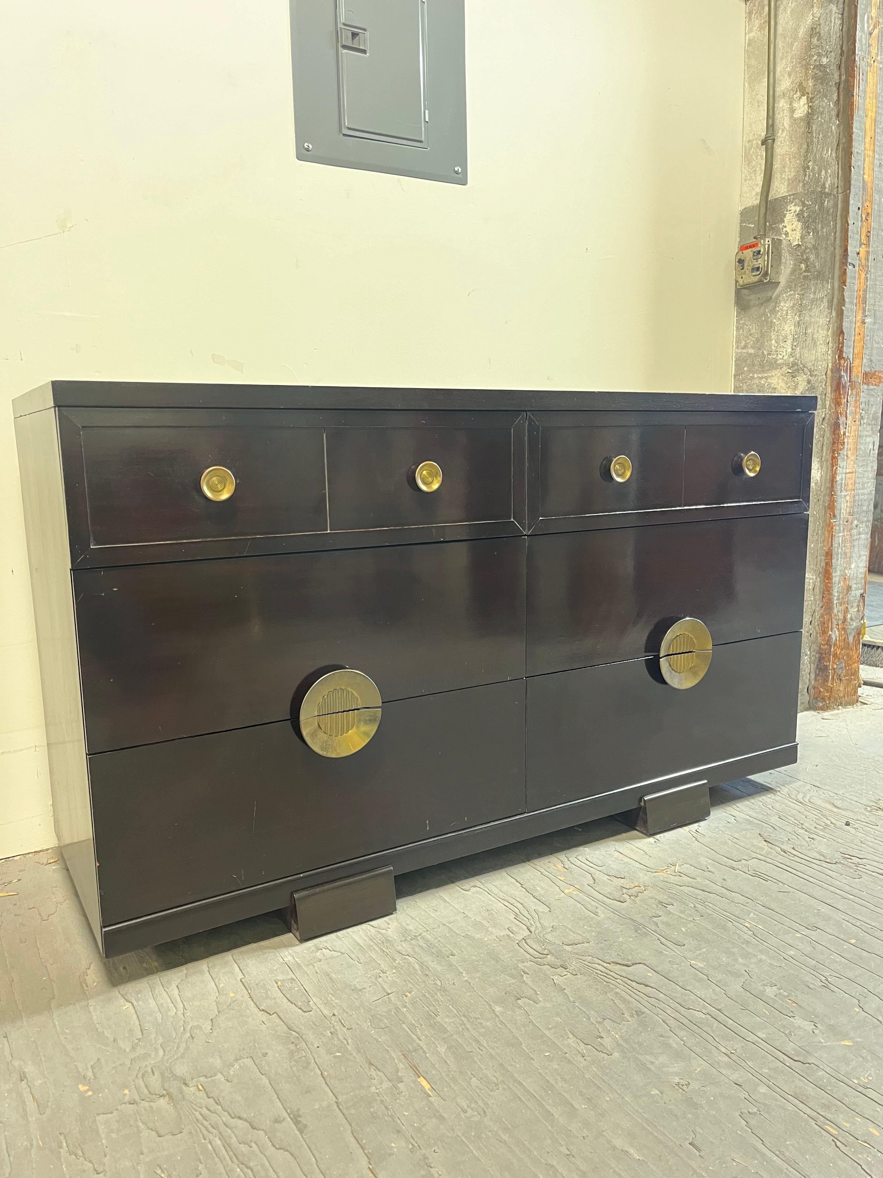 simple lines with a pop in this classic mid century 6 drawer dresser by Mengel Furniture Co. Signature Raymond Lowey styling that draws the eyes in with big brass split pulls. Deep drawers for ample storage. 
Curbside to NYC/Philly $450 