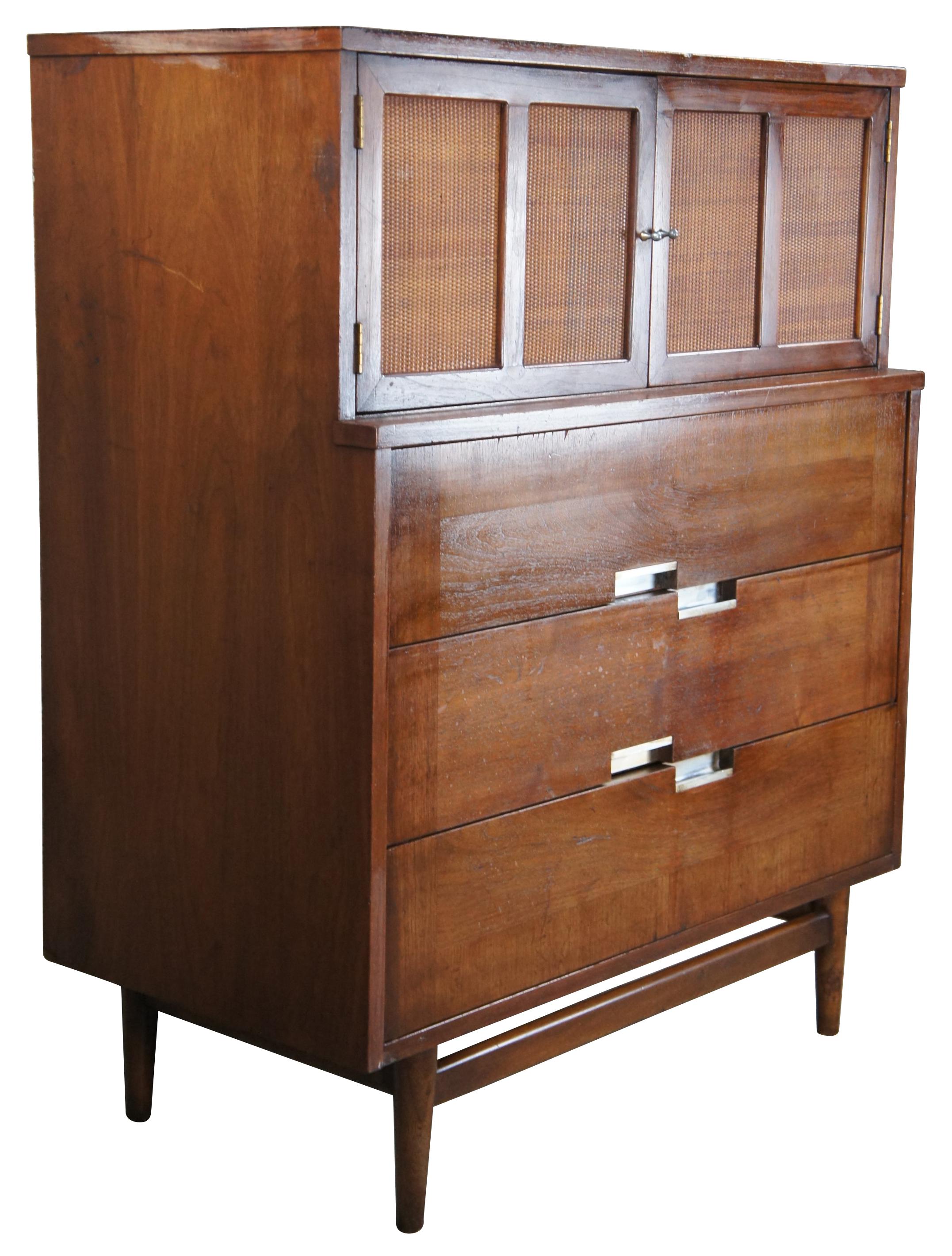 Mid-Century Modern Accord Bachelor chest of drawers designed by Merton Gershun, American (1909-1989) for American of Martinsville. Made of walnut featuring inset X top with upper cane panel cabinet that opens to two drawers, over three more drawers