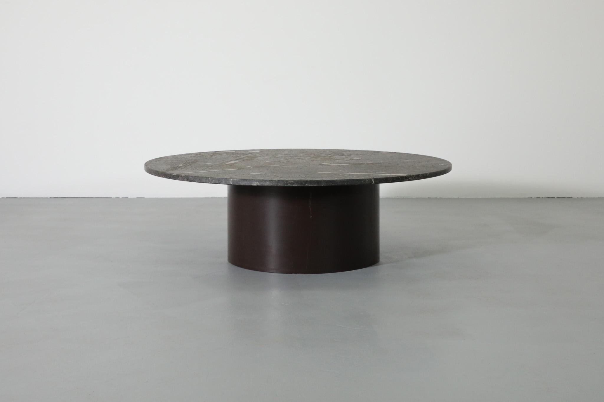 Stunning, 1960, Metaform style round fossil stone coffee table with brown enameled metal pedestal base. Beautiful fossilized sea shells are naturally embedded in the stone that was used for the top. A unique piece. Table's in good original condition