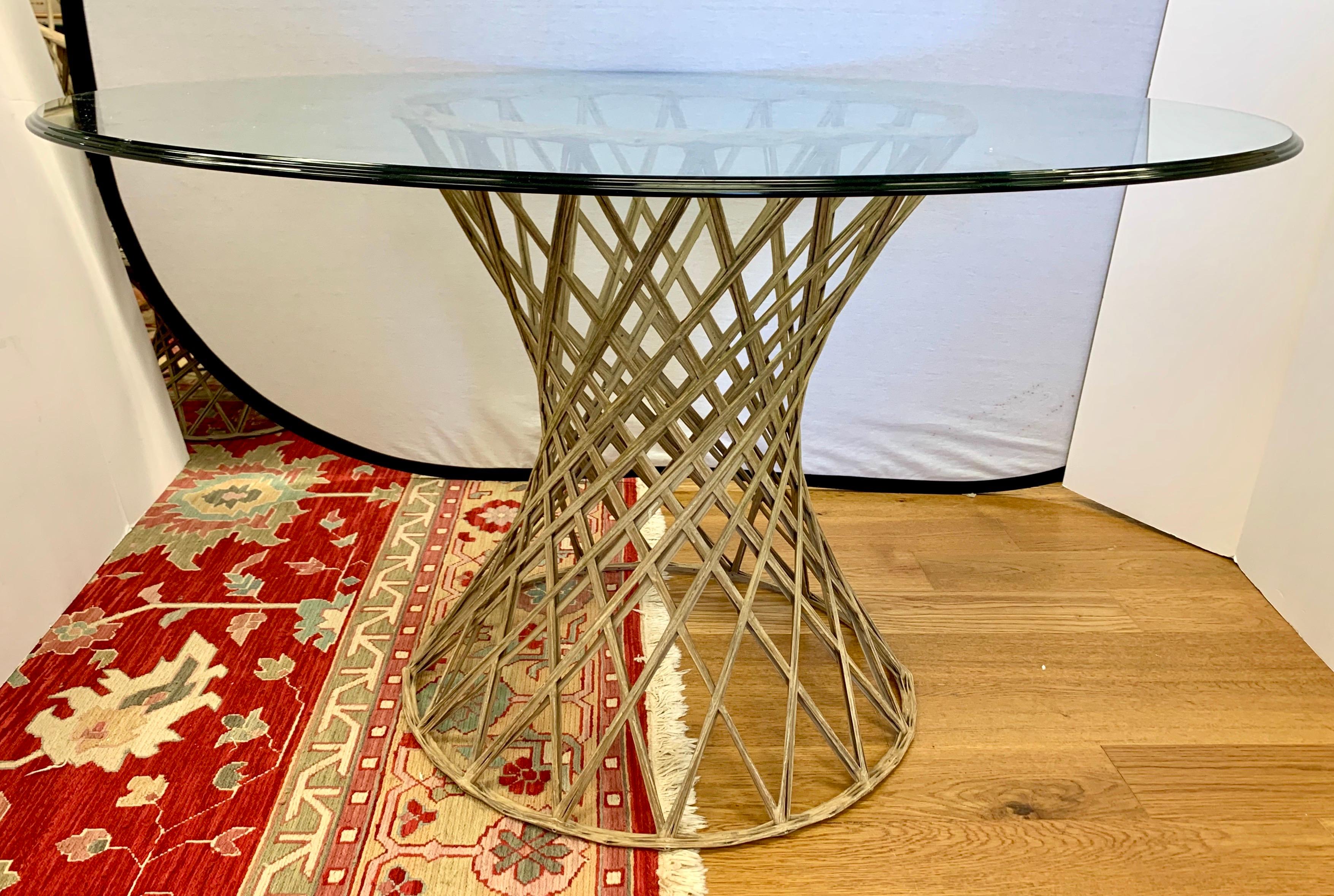This beautiful mid century modern patio set by Russell Woodard includes four chairs and a round glass top dining table. Unique design made of woven fiberglass with tulip shaped bases. The patio set consists of 4 barrel swivel chairs and matching