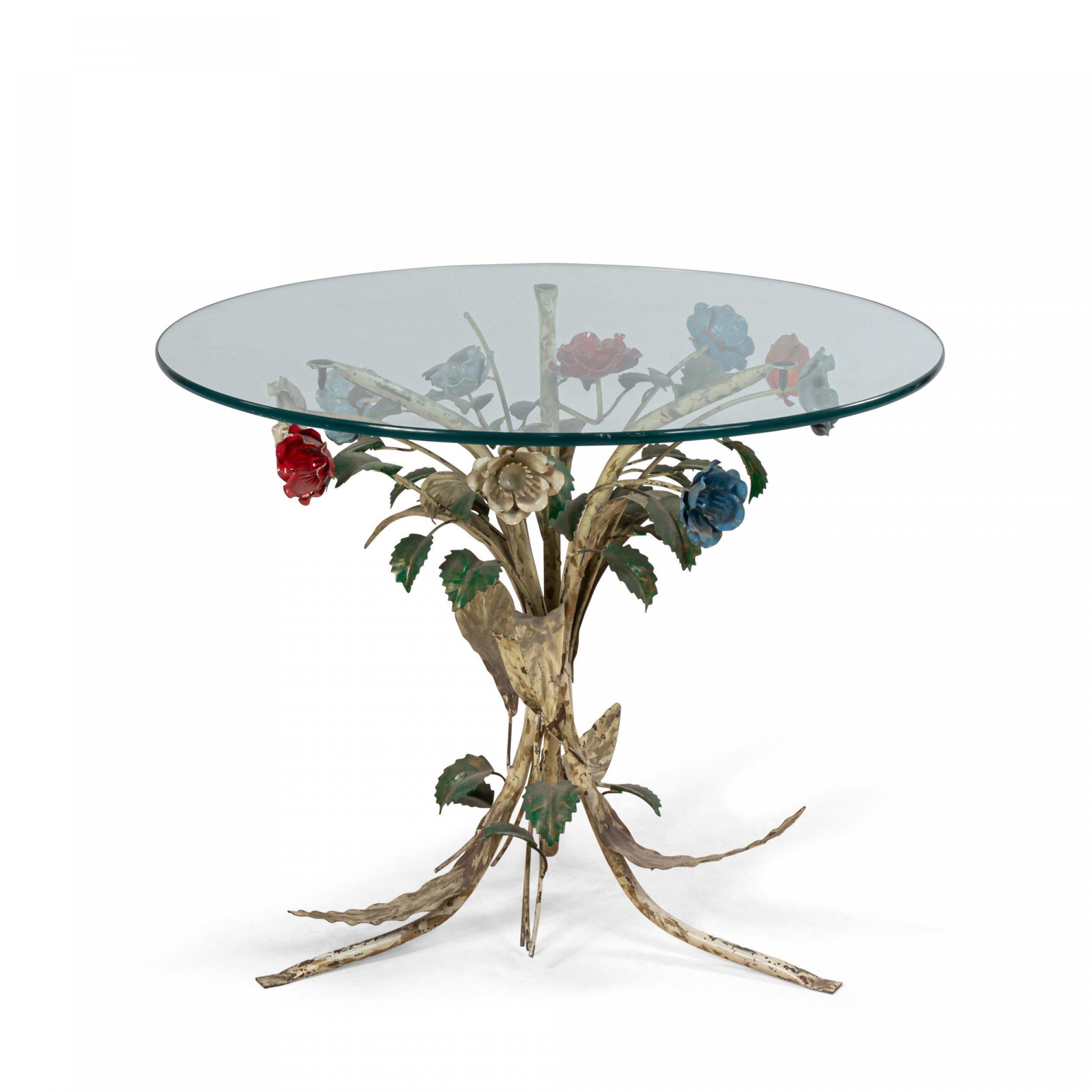 Midcentury coffee table with painted shaped metal floral base and circular glass top.