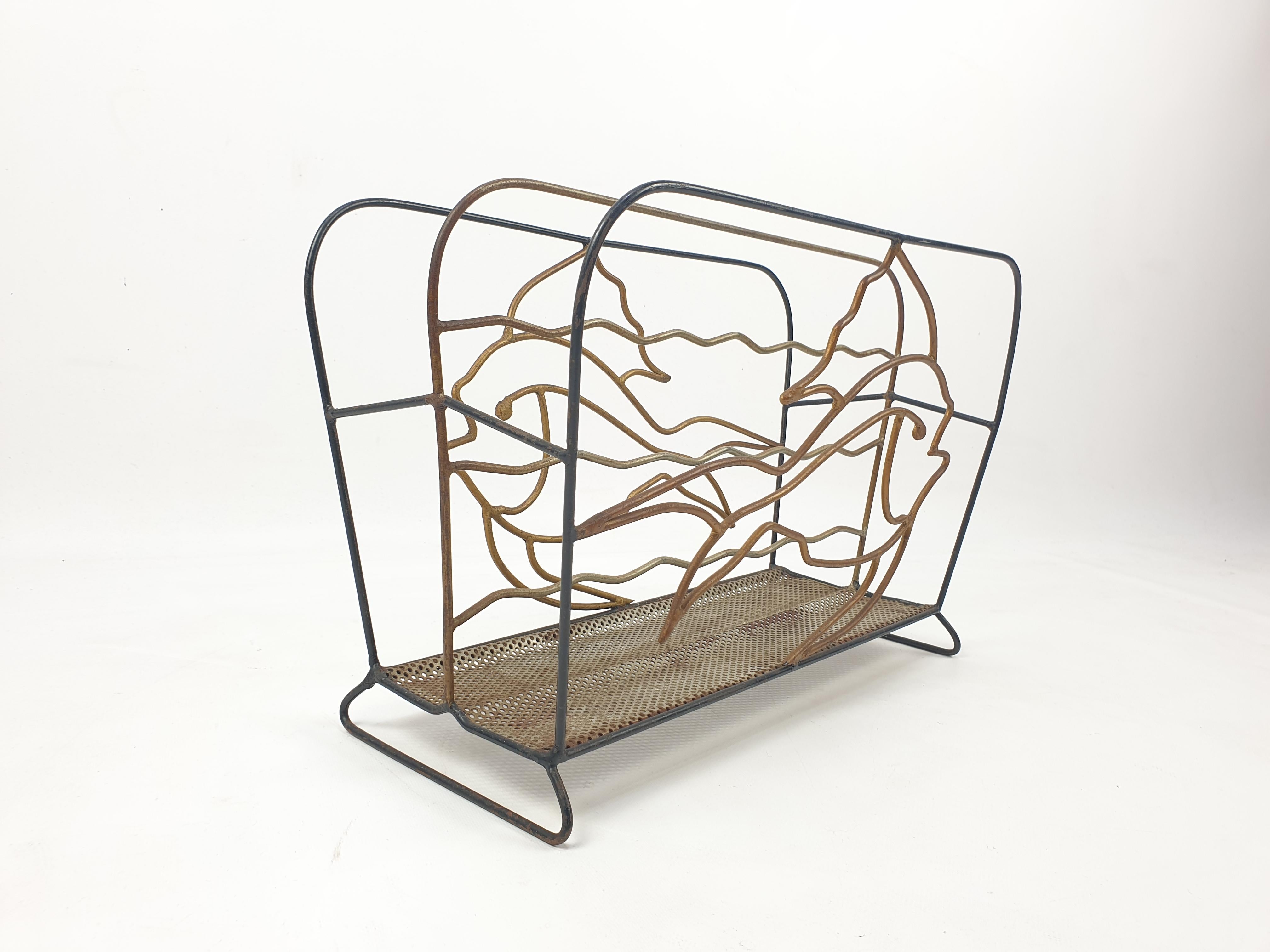 Very nice metal magazine rack made in France in the 50's. Illustrating two fishes on both sides.