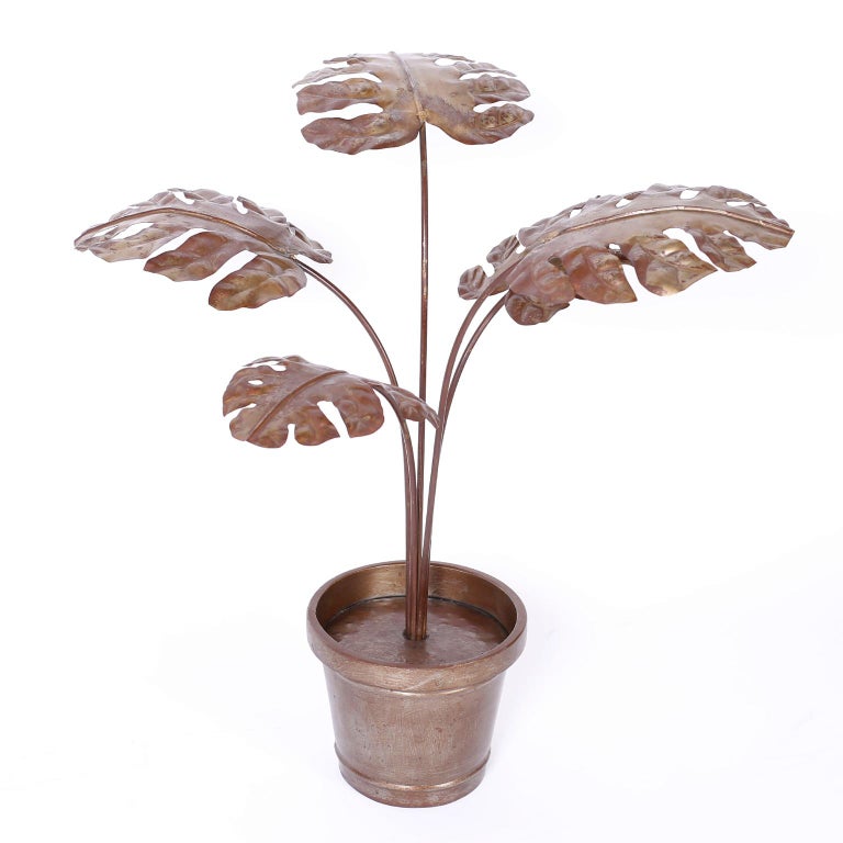 Chic midcentury life-size potted plant or philodendron sculpture, handcrafted in metal with a stylized form and an acquired oxidized finish.