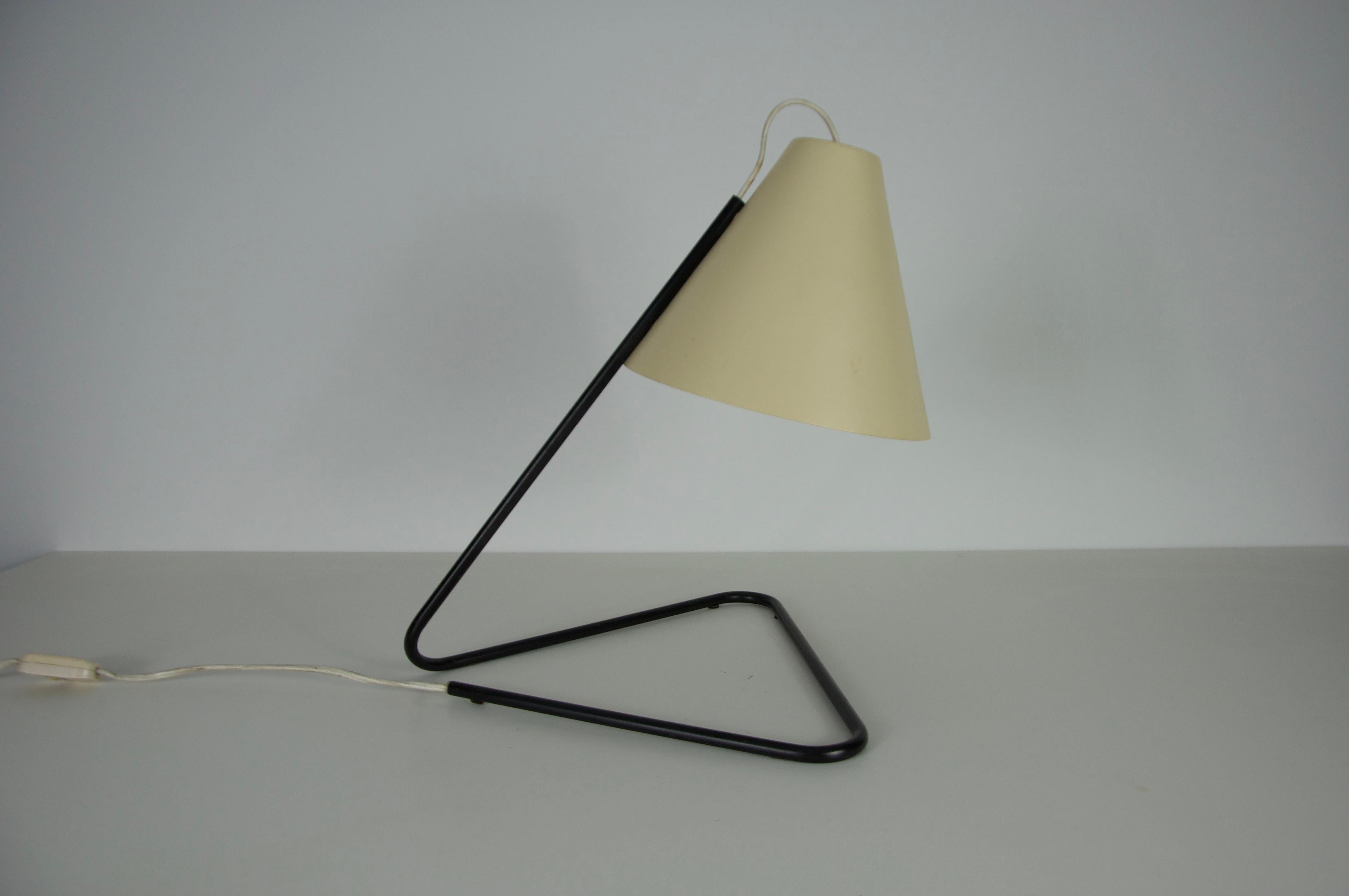 Questa elegante lampada da tavolo degli anni '60 è uno splendido esempio di design italiano della metà del secolo scorso. Realizzata in metallo, presenta un'estetica elegante e minimalista con una struttura geometrica nera e un paralume bianco