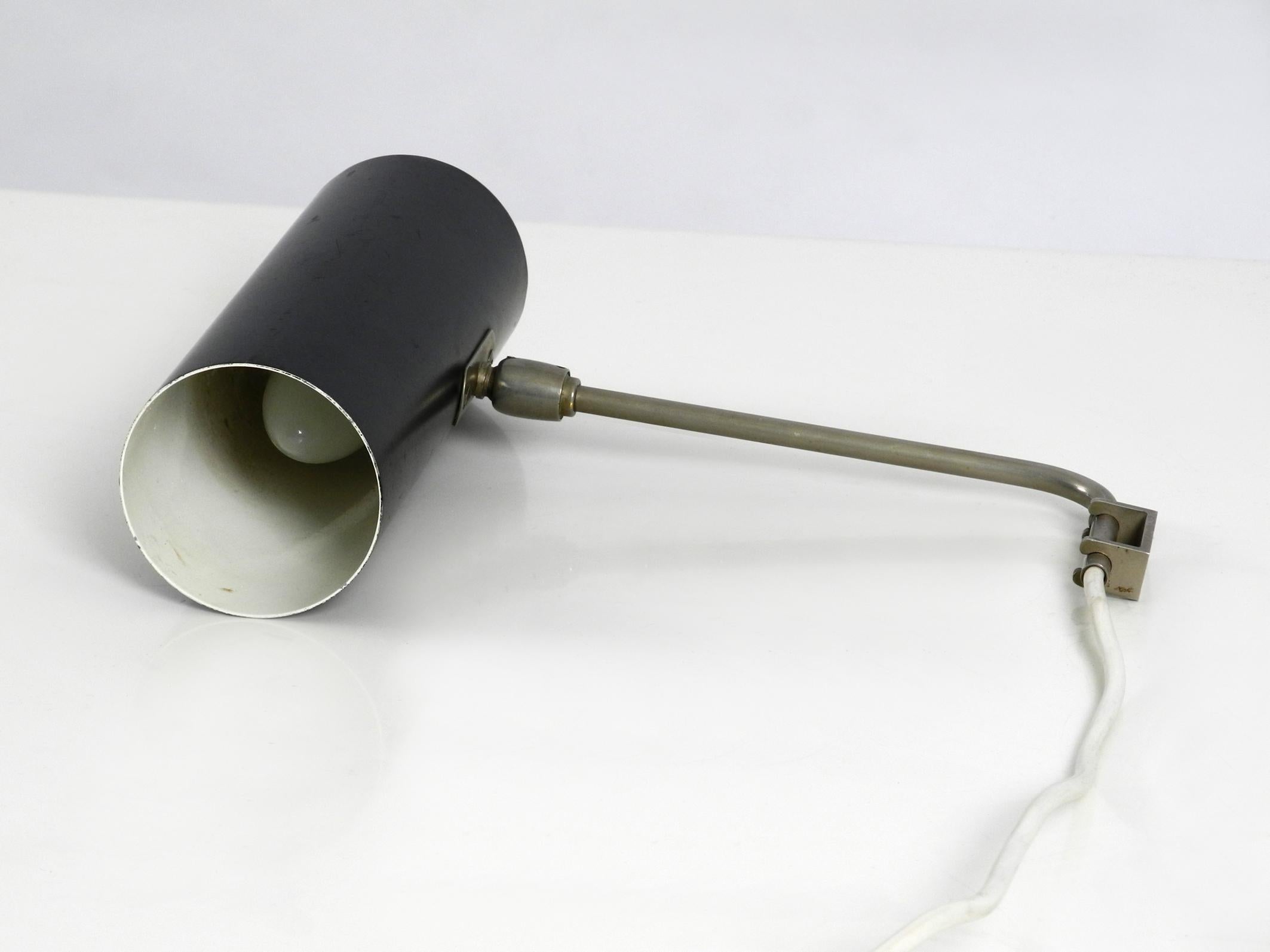 Original mid century metal wall lamp with freely movable neck.
Manufacturer of Kaiser lights. Made in Germany.
Metal screen. Neck and wall mounting made of nickel-plated metal.
Infinitely variable in all directions.
Beautiful minimalist design
