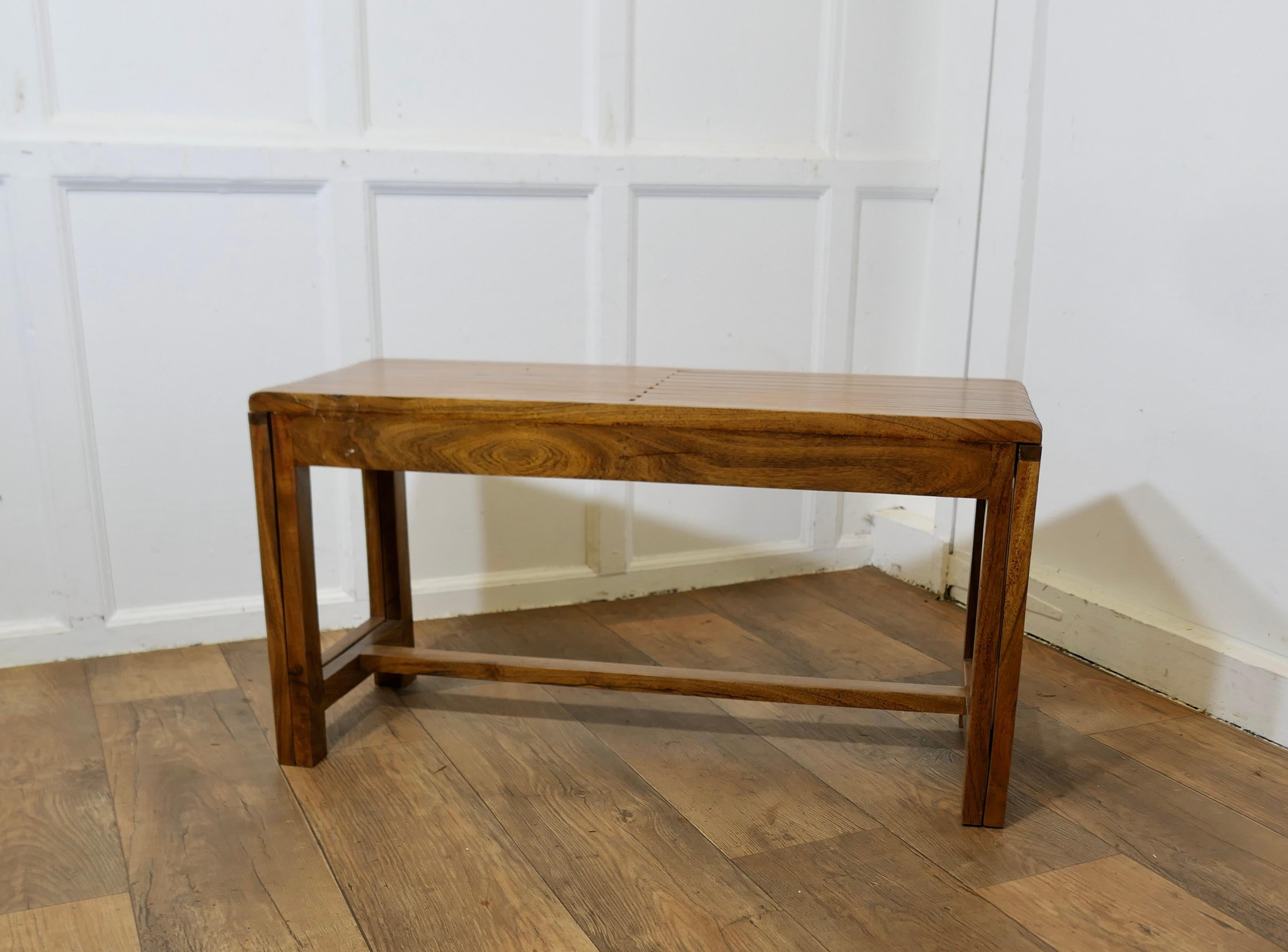 Mid Century Metamorphic Extending Teak Luggage Rack, Coffee Table

This is a good sturdy piece, it is made in Teak and has sleek lines, the top extends by drawing out both or one side of the slatted top, the stand is arobust piece and will take the