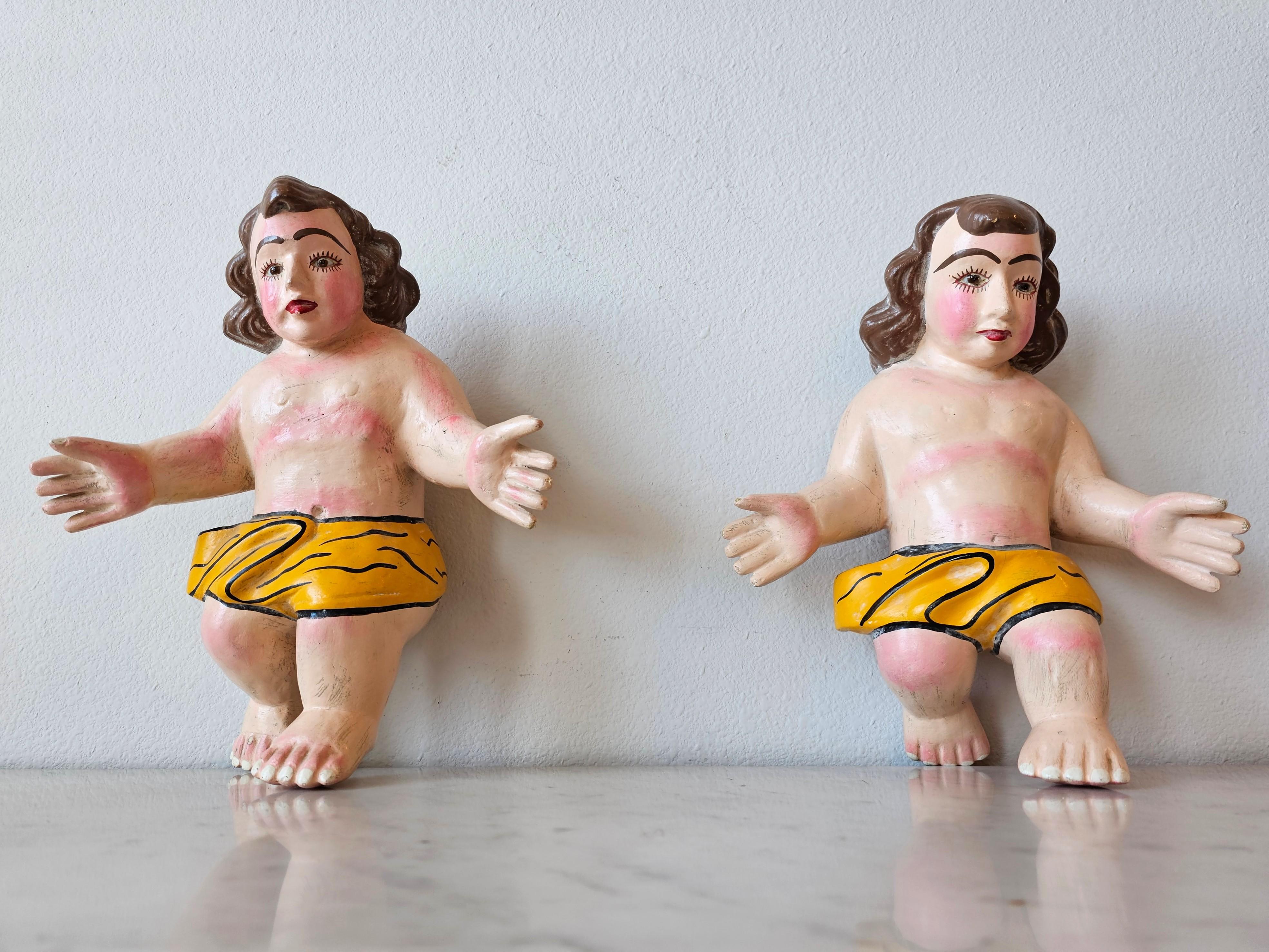 A charming pair of vintage Mexican folk art hand carved and painted Infant Jesus religious figures. circa 1960

Handmade in Mexico, mid-20th century, Baroque santo style, depicting (2) Baby Christ figures, modeled in seated position with arms open,