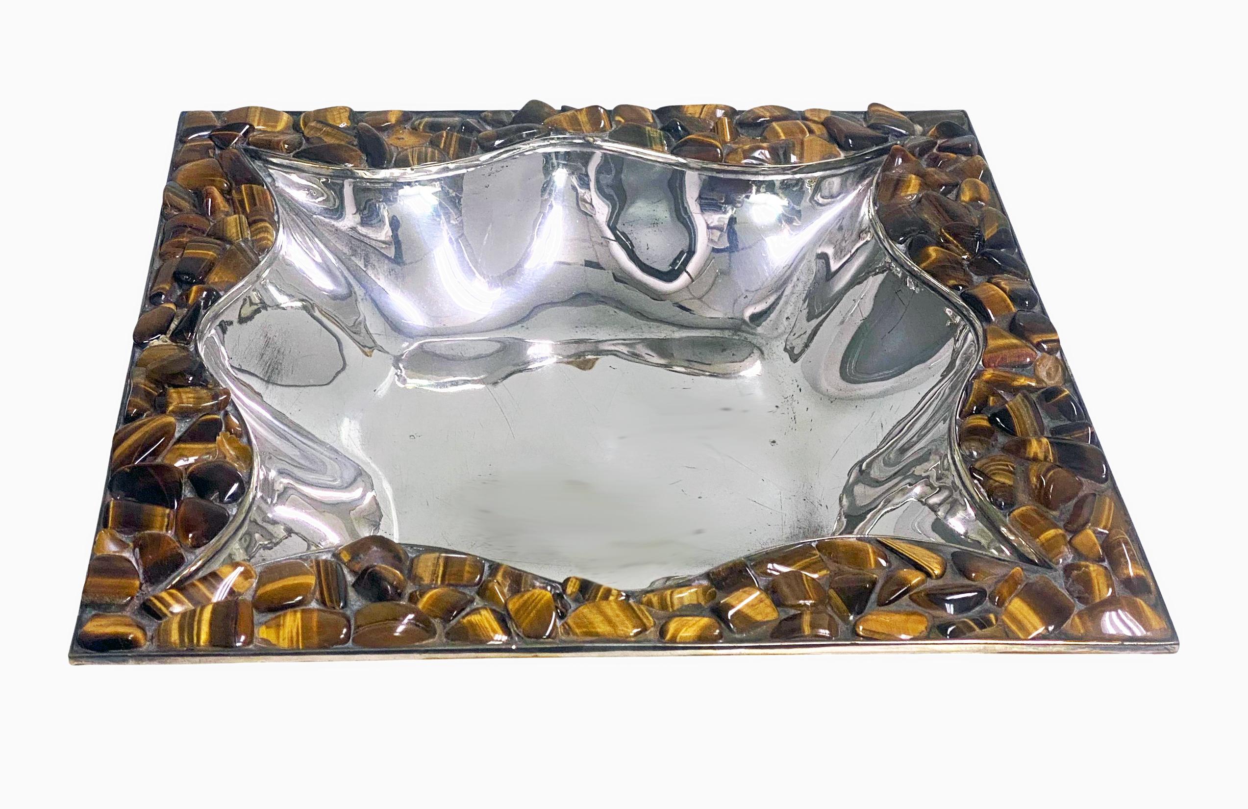 Mid century Mexican Los Castillo hand wrought silver plate and tigers eye dish centerpiece. The large Dish on four bracket feet, tapered lobate panel sides supporting large square border set with numerous tigers’ eye, a couple lacking on close