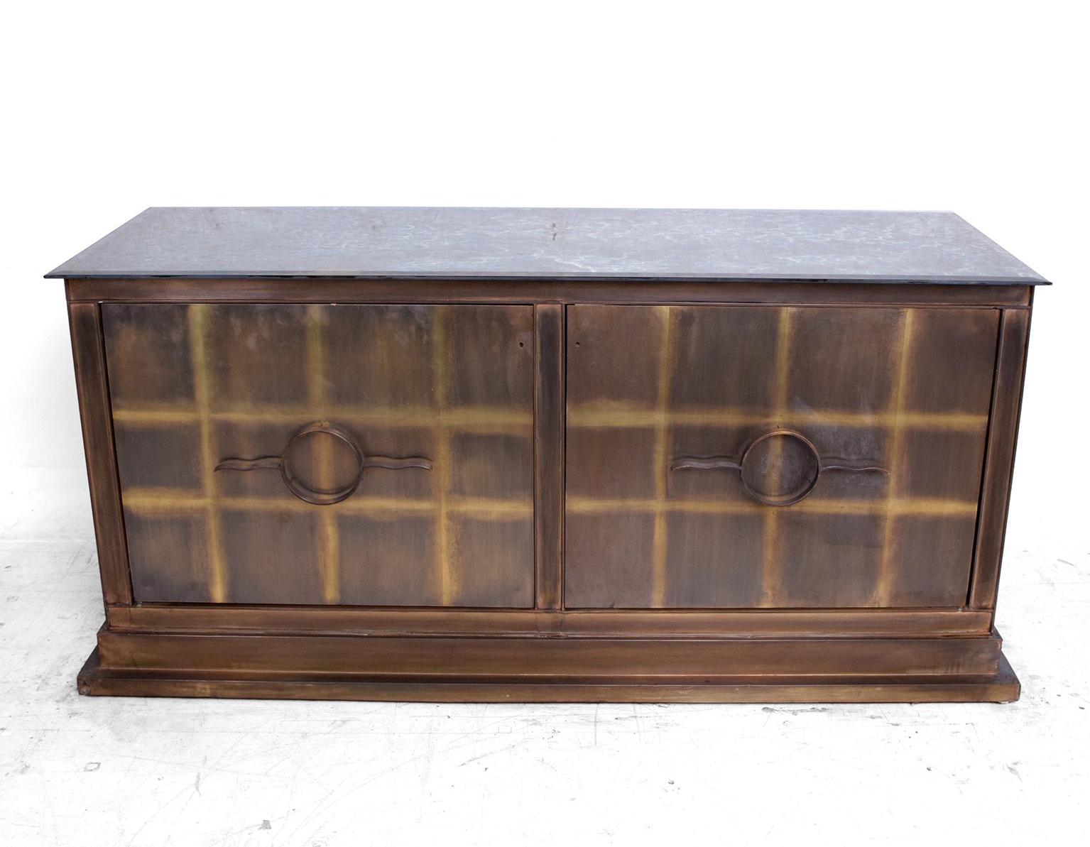 For your consideration a pair of bronze credenzas. Constructed with solid sheets of bronze and metal frame. Eglomized glass top with beveled edges.

Unusual pull handles. 

Credenzas were custom-made for a upscale Hotel in Mexico City.
There is