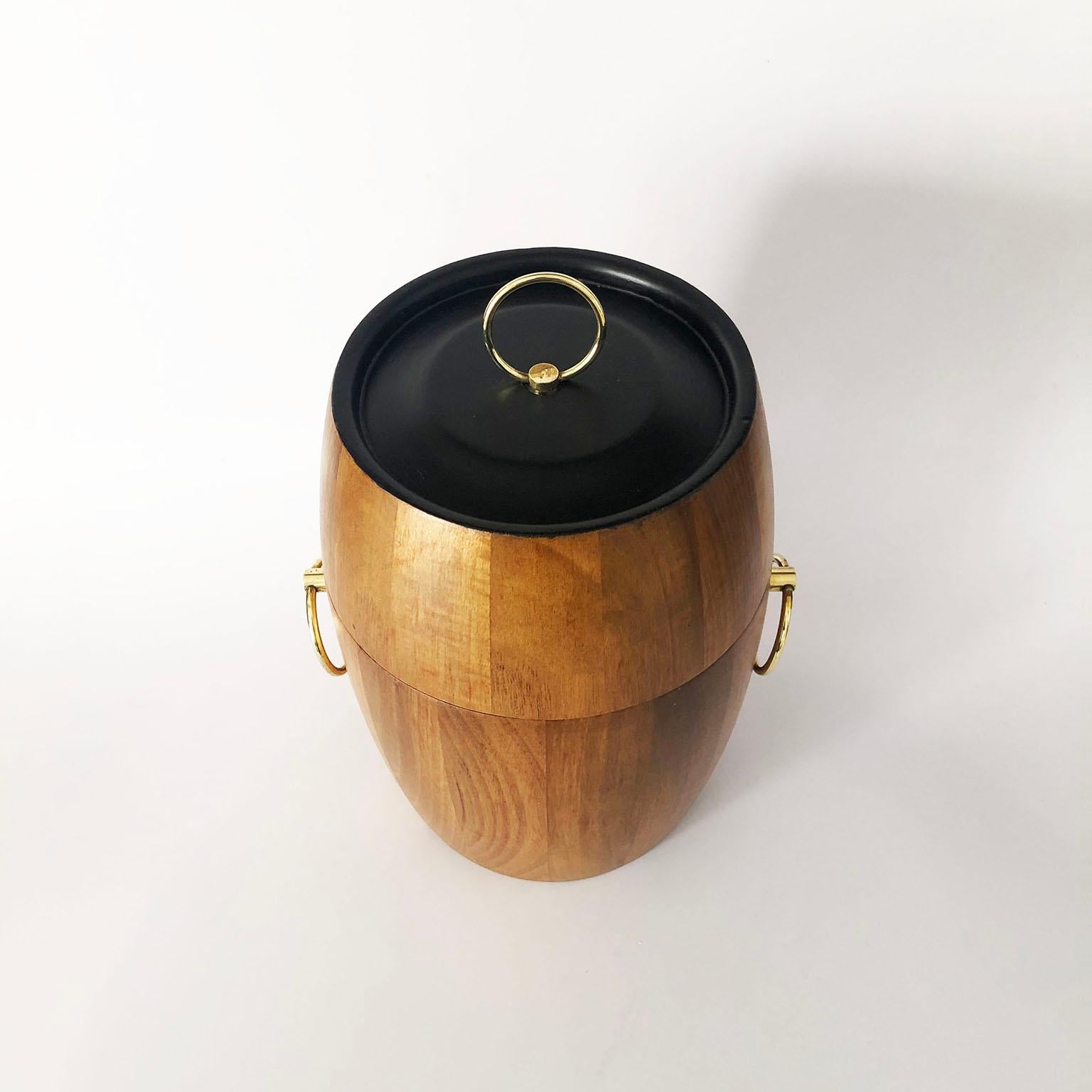 Circa 1950, we offer this mid-century Mexican modern ice bucket made in tropical woods. Recently restored.