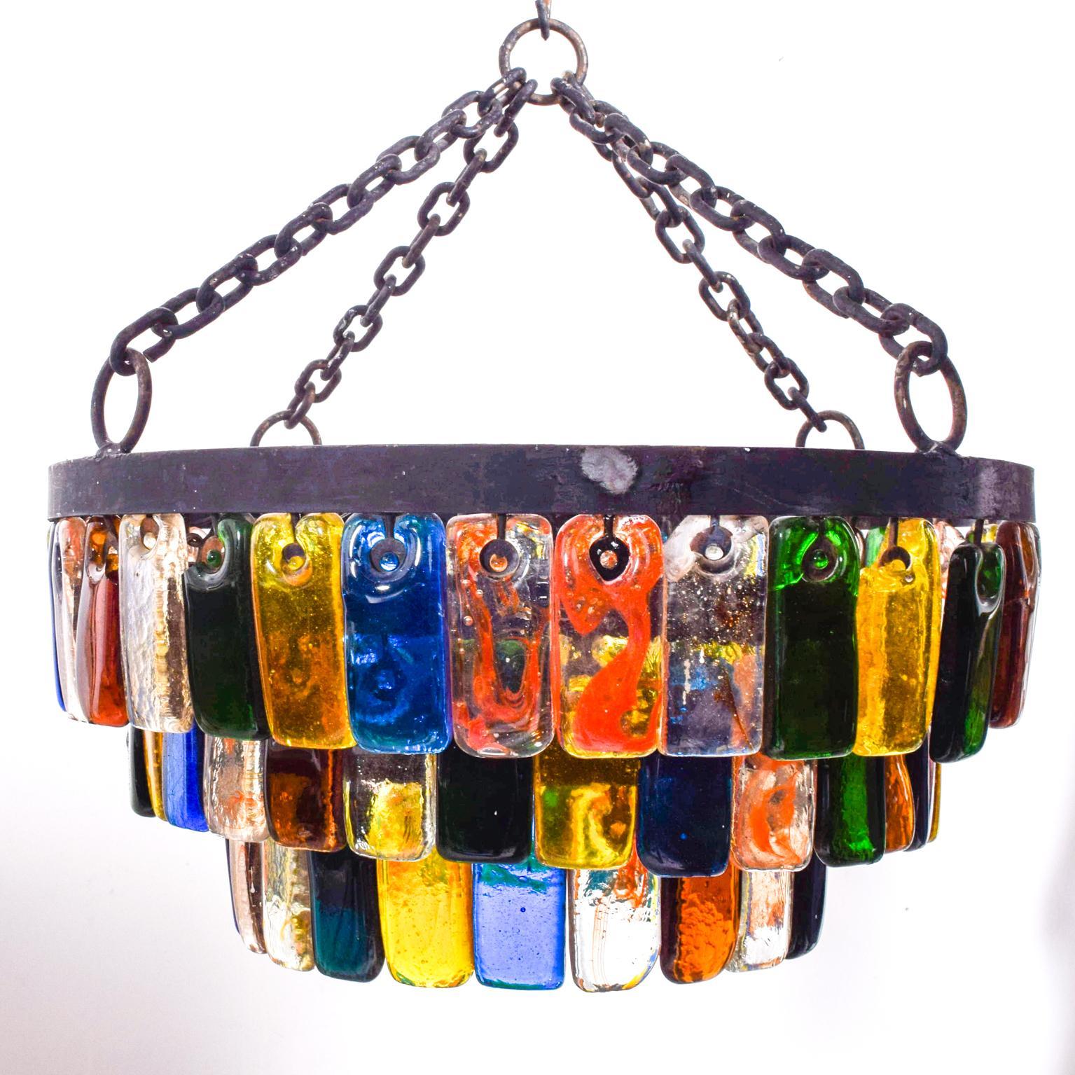 We are pleased to offer for your consideration, a vintage chandelier designed by Delfinger for FEDERS.
Made in Mexico circa the 1970s.
Handblown color glass baguettes in three different layers. Beautiful colors.  Rewired. Dimensions: 20