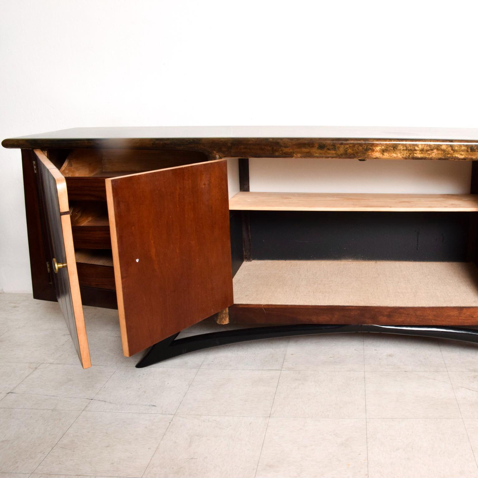 For your consideration, a midcentury Mexican Modernist credenza attributed to Eugenio Escudero with Pepe Mendoza pulls. Sculptural shape with gold leaf top and beautiful art patina. Feature drawers on each side (three) and open storage in the