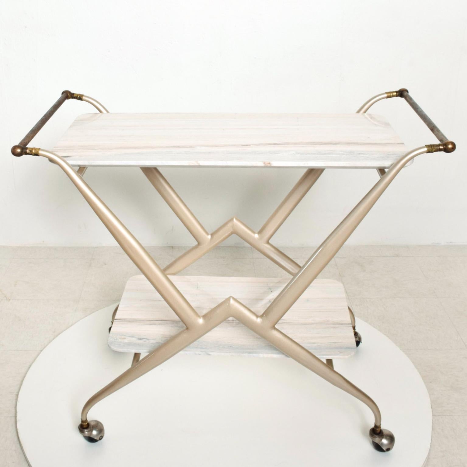 We are pleased to offer for your consideration a beautiful service table. It can be used as a service bar, bakery service table, side or wall console. Constructed with tapered tubular steel with an oval shape. Brass hardware mounted in the original