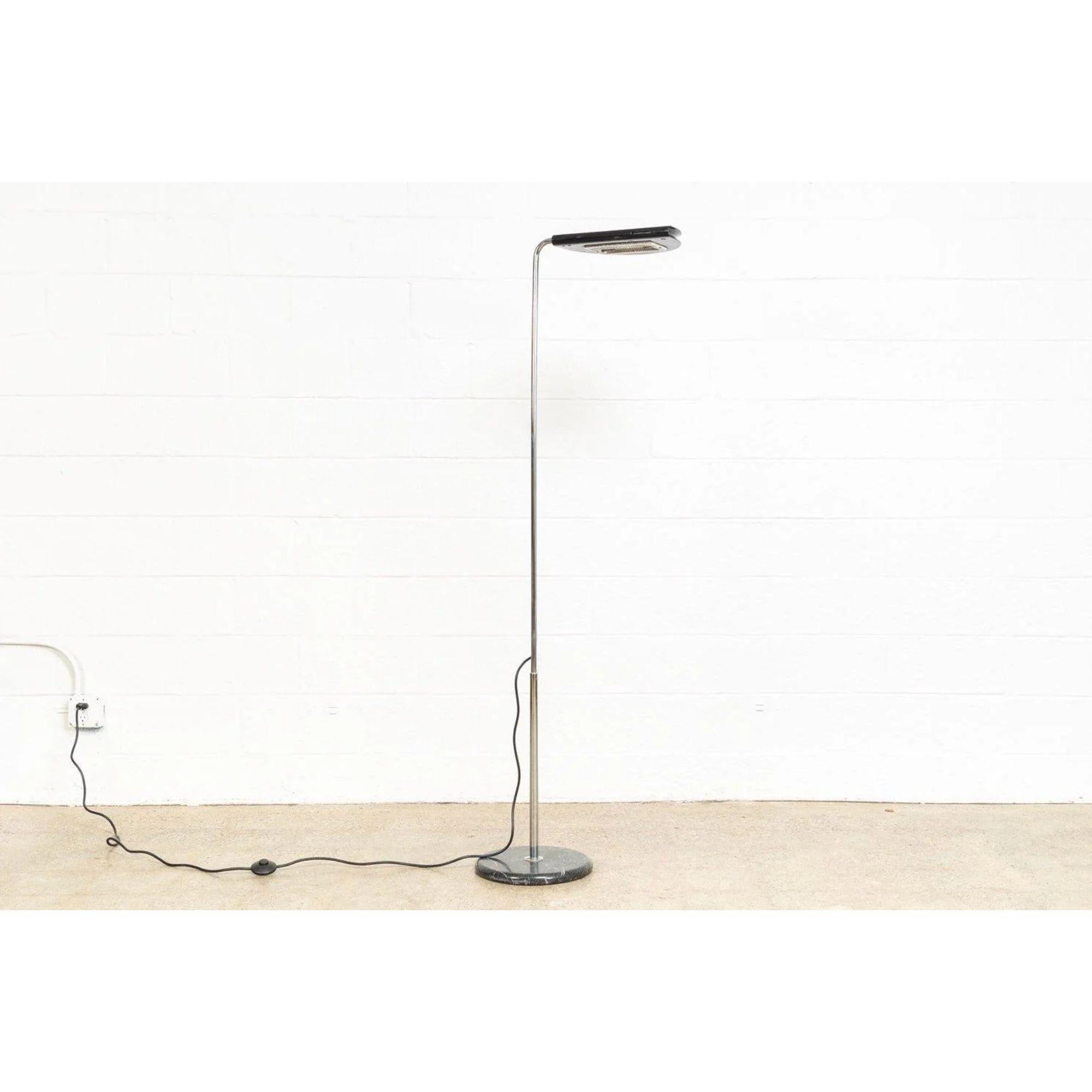 This vintage Mid-Century Modern Italian Bruno Gecchelin “Mezzaluna“ black floor lamp manufactured by Skipper and made in Italy is circa 1970. The sleek, Space Age, modernist design features a black Carrara marble base with a chrome-plated steel