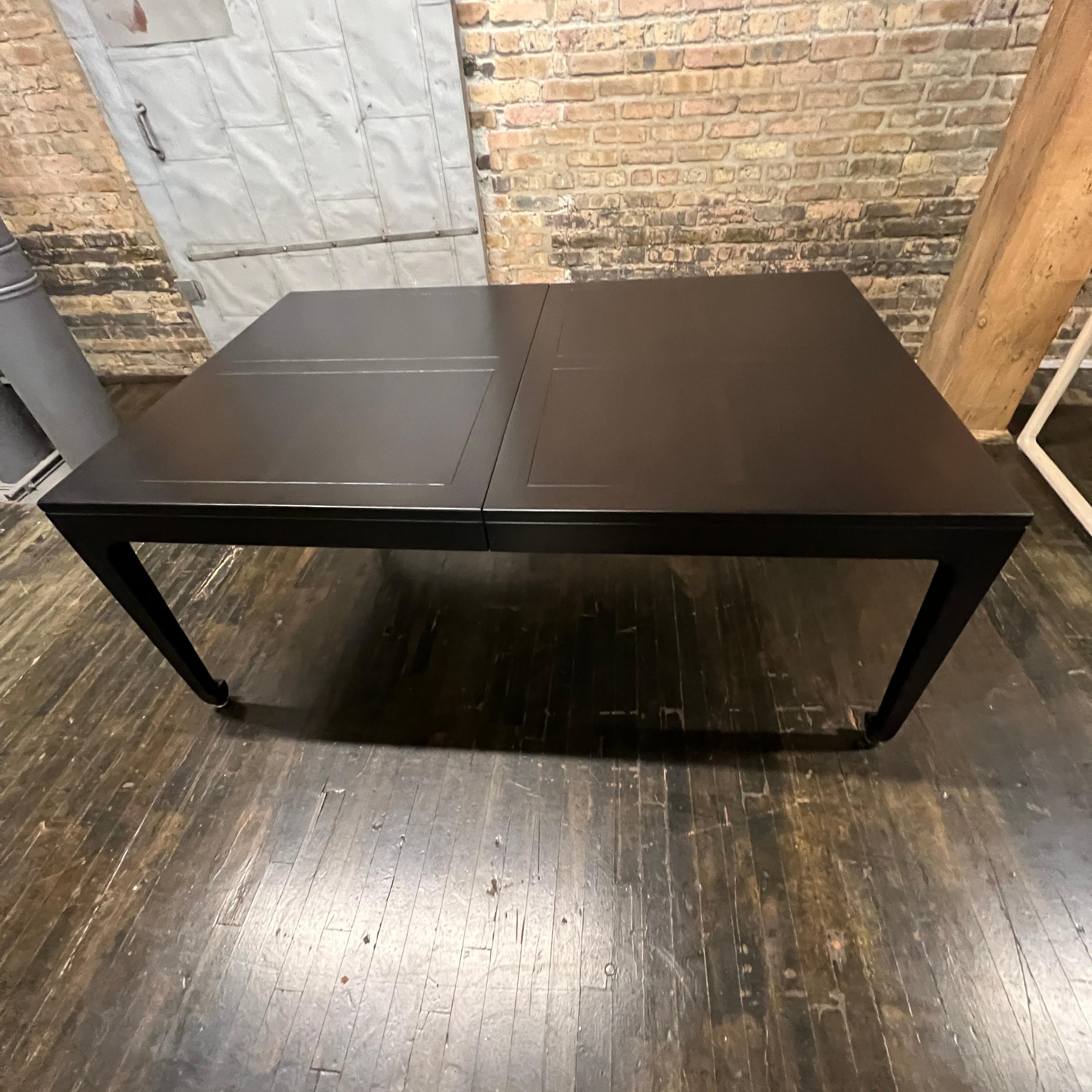 A stunning extension table that Michael Taylor designed for Baker Furniture. This beautiful and functional table is ready for immediate install. This table starts out as a rectangle but with three impressive leaves it can extend to 122