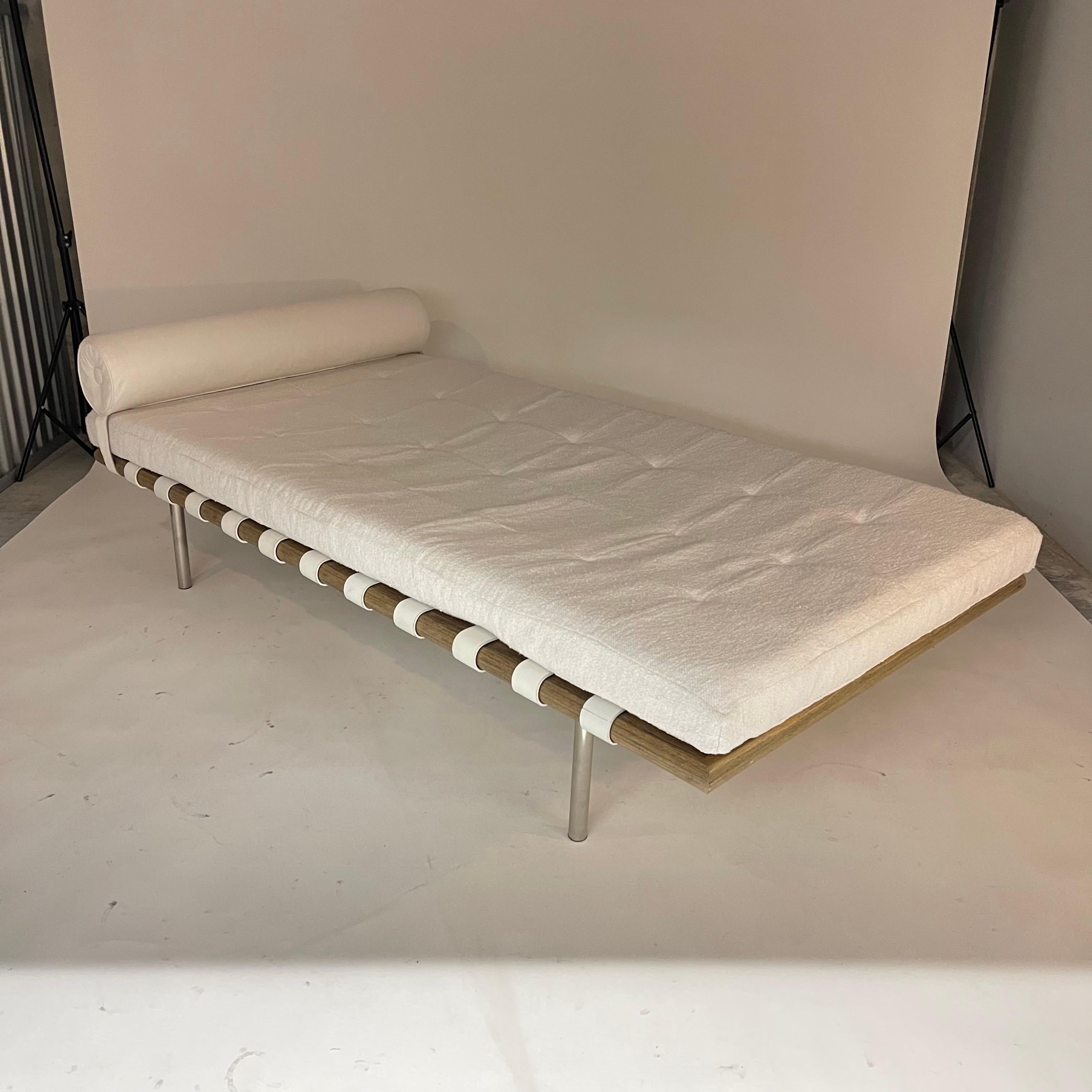 Original Vintage Midcentury chaise lounge rendered in a driftwood stained oak frame polished steel legs leather bolster cushion and strapping with a Holly Hunt Great Plains upholstered biscuit tufted mattress cushion.

Original straps were left to