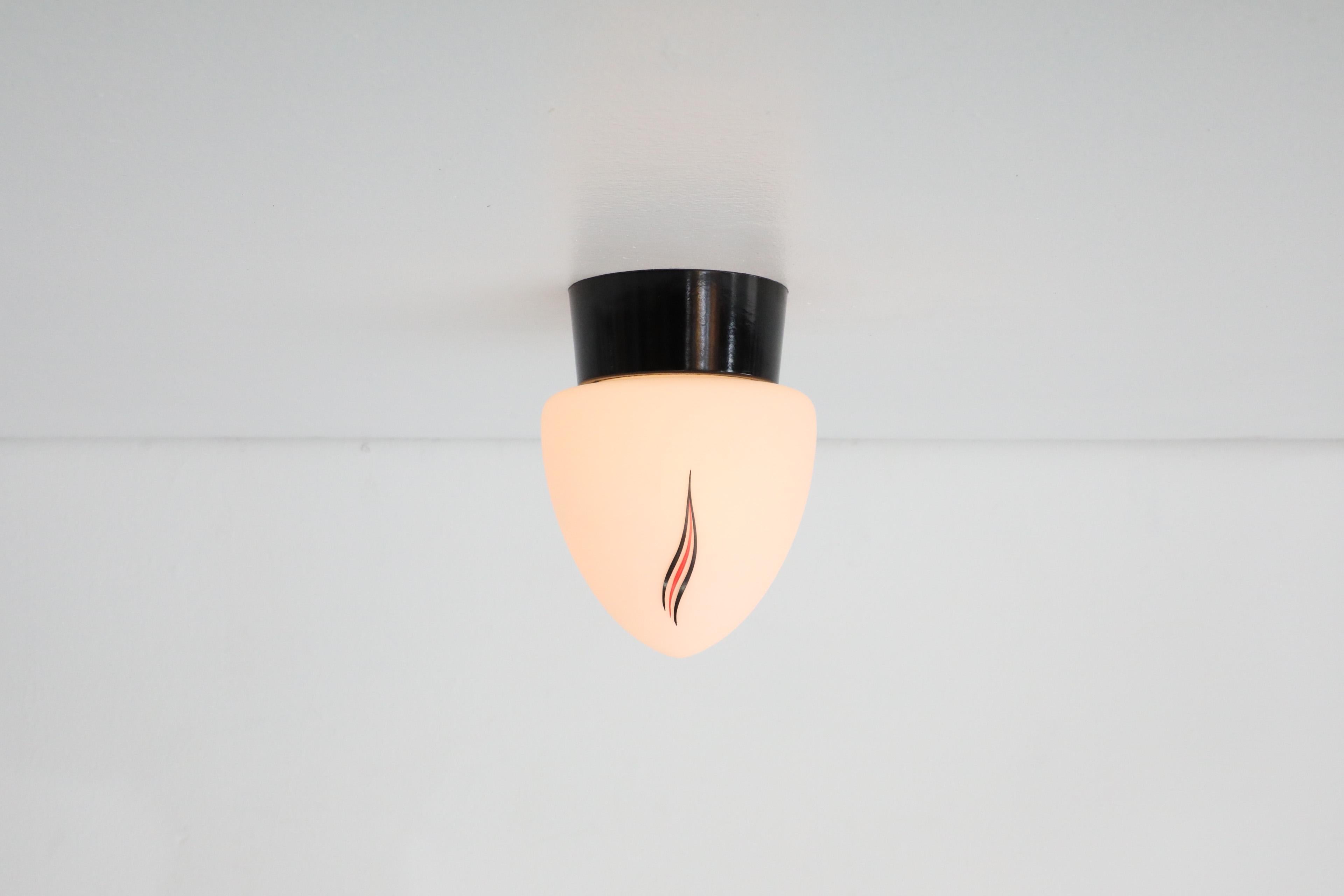 Mid-Century Modern Mid-Century Milk Glass Sconce with Printed Flame Detail and Black Acrylic Base