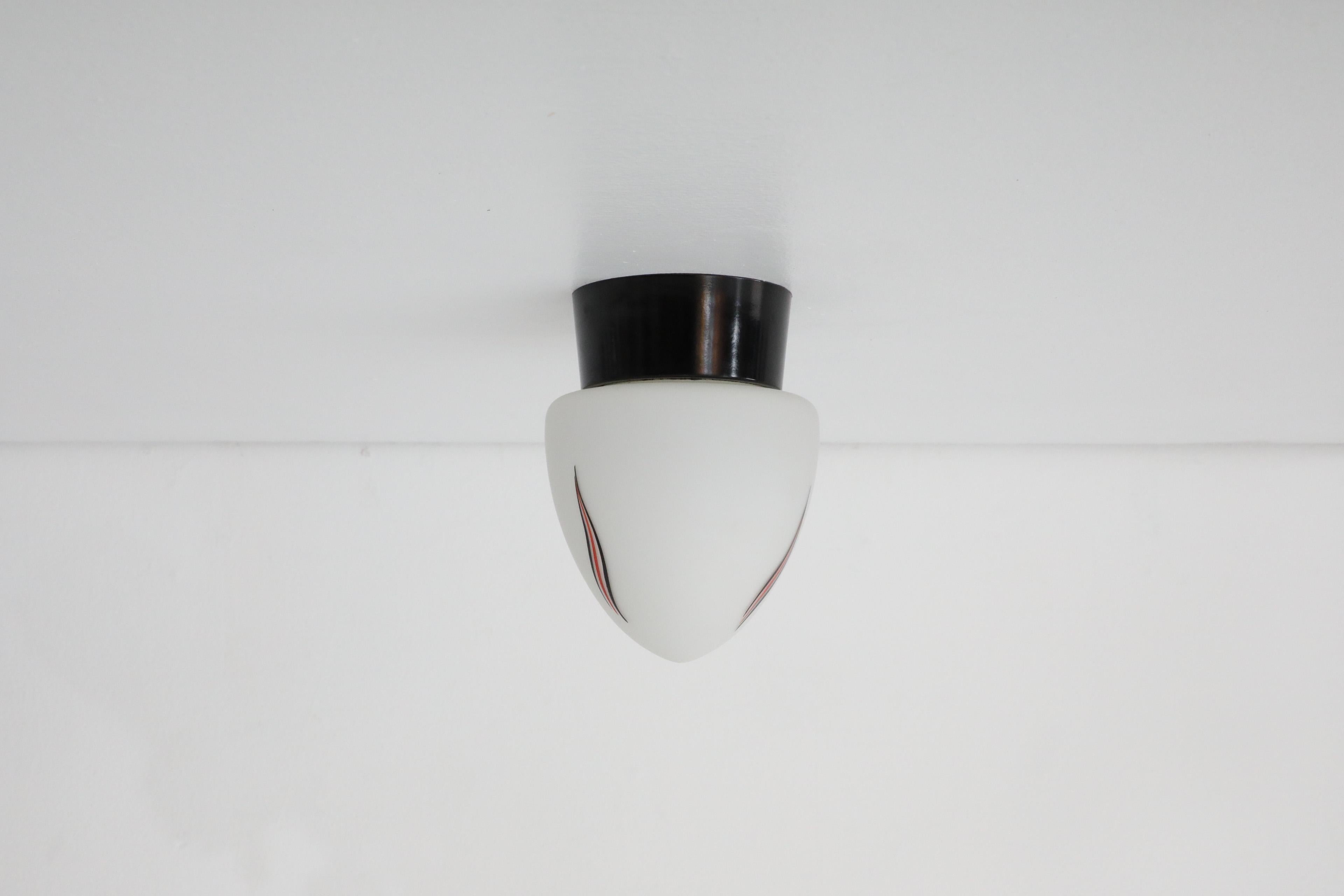 Mid-Century Milk Glass Sconce with Printed Flame Detail and Black Acrylic Base In Good Condition In Los Angeles, CA