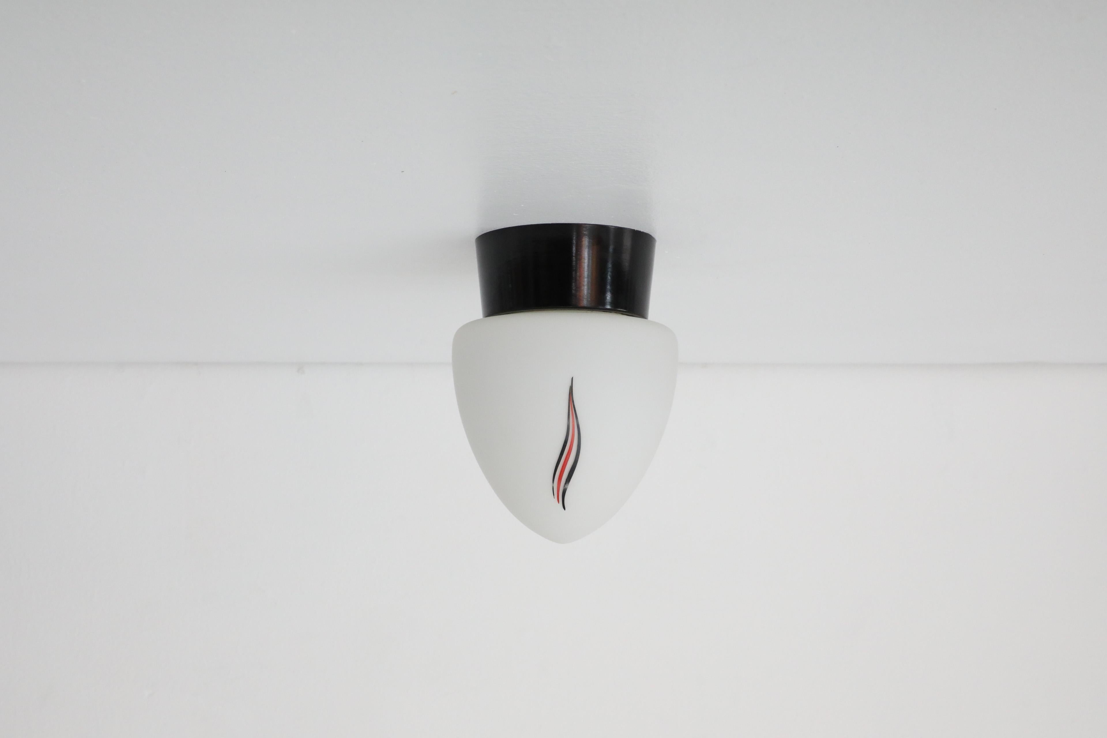 20th Century Mid-Century Milk Glass Sconce with Printed Flame Detail and Black Acrylic Base