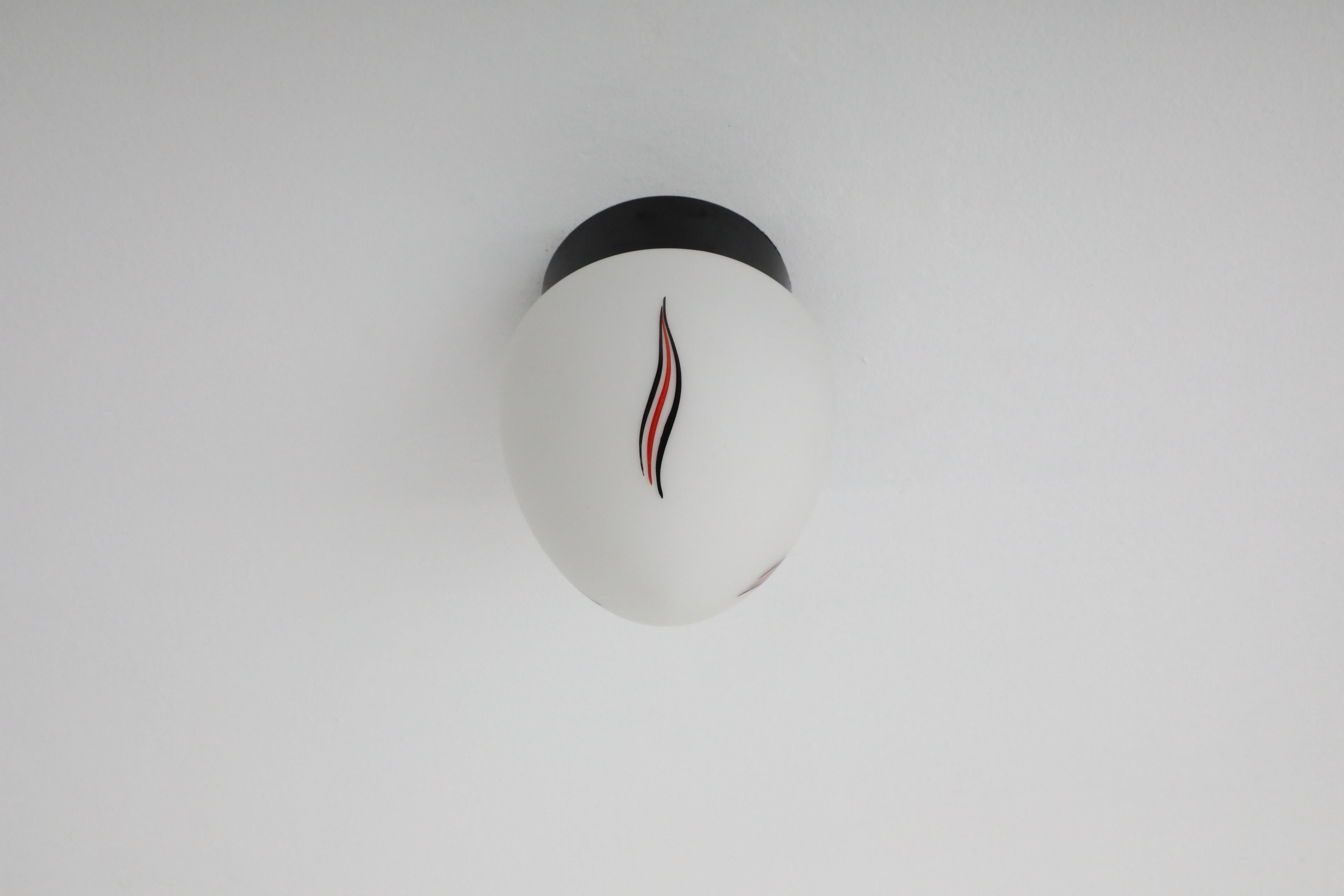 Mid-Century Milk Glass Sconce with Printed Flame Detail and Black Acrylic Base 1