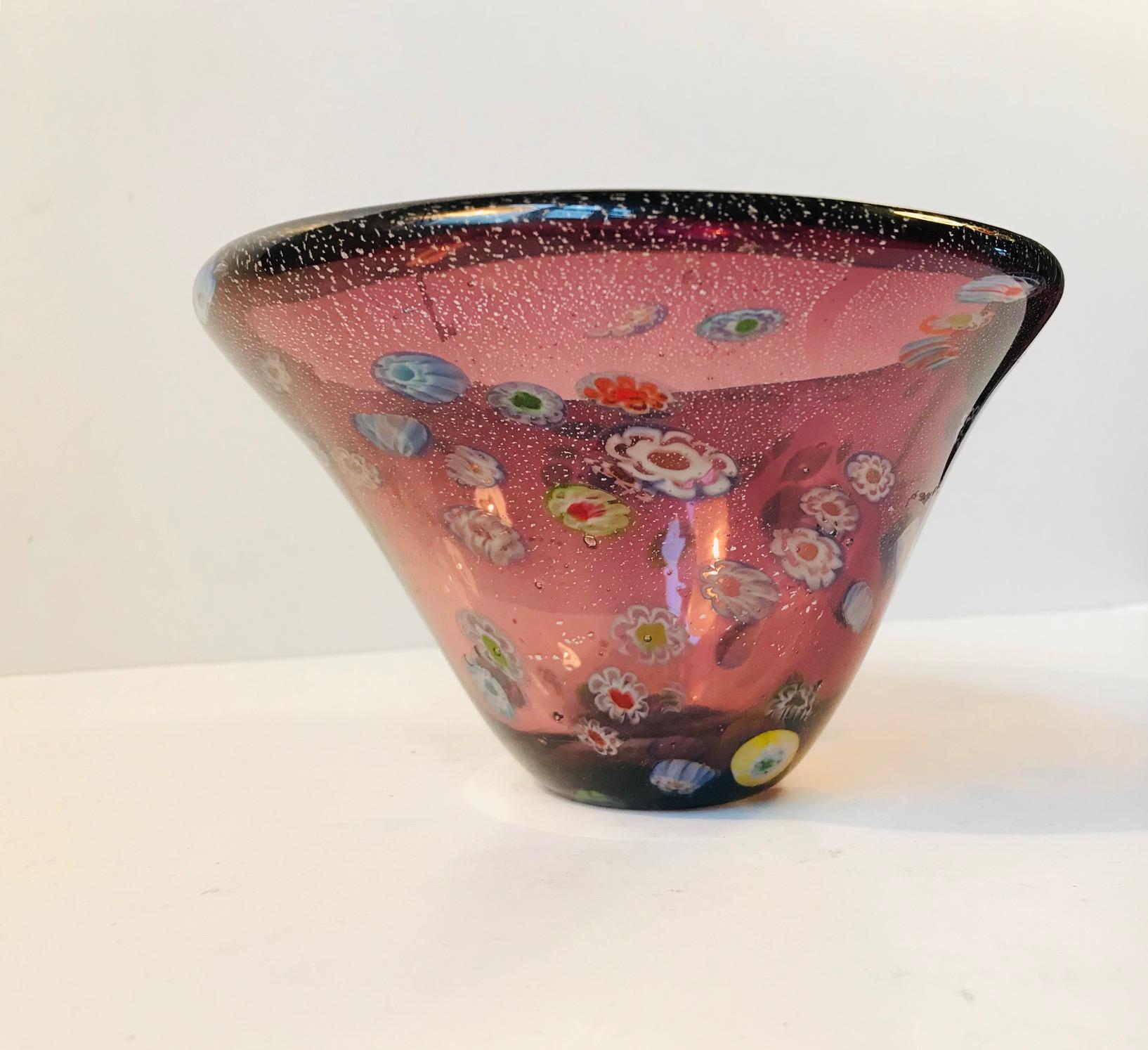 This colorful Murano glass bowl is decorated with a technique called Millefiori, meaning a thousand flowers. It was manufactured in Italy during the 1960s or 1970s.